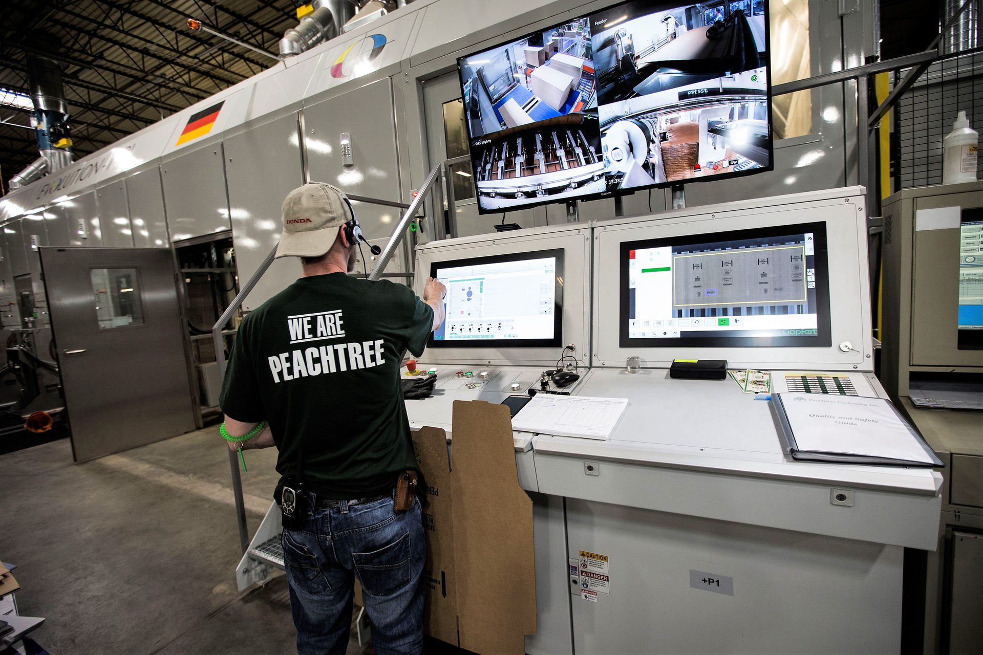 Peachtree employee operating the Gopfert Evolution 5-Color Die Cutting Press