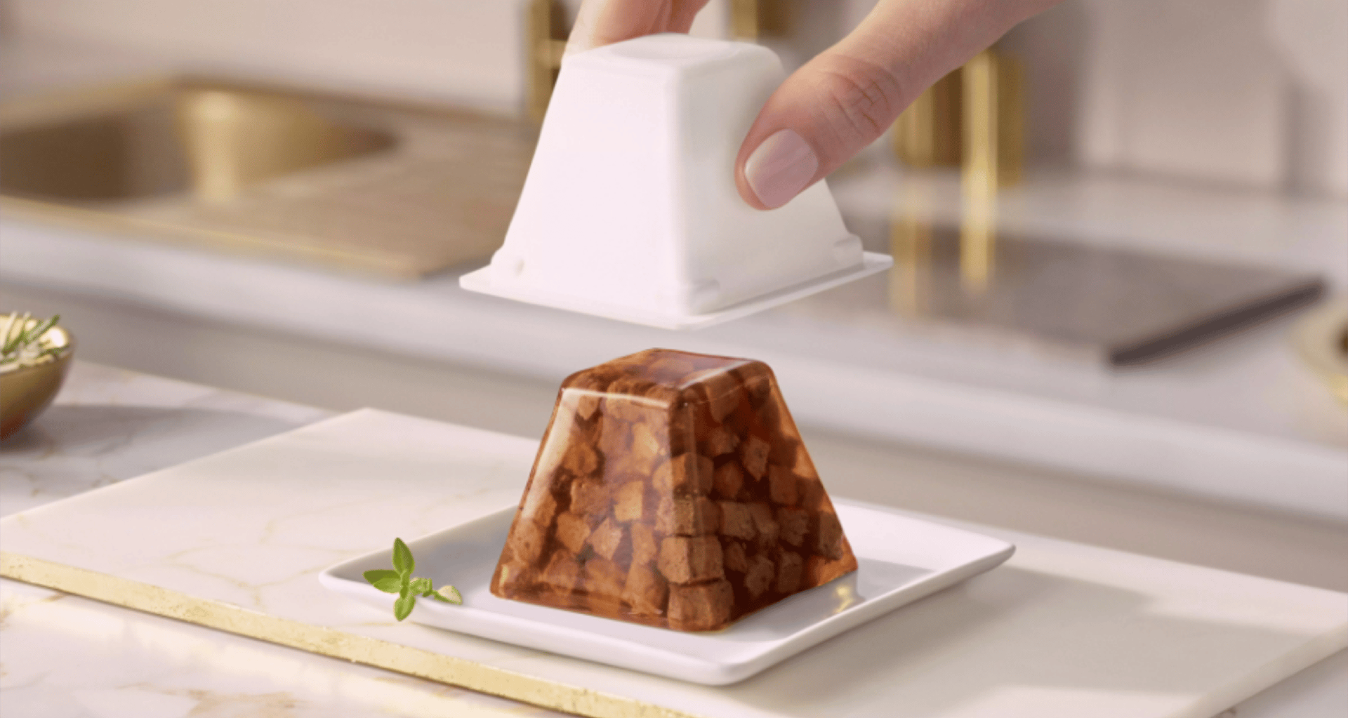 Person removing the cat food from the pyramid packaging