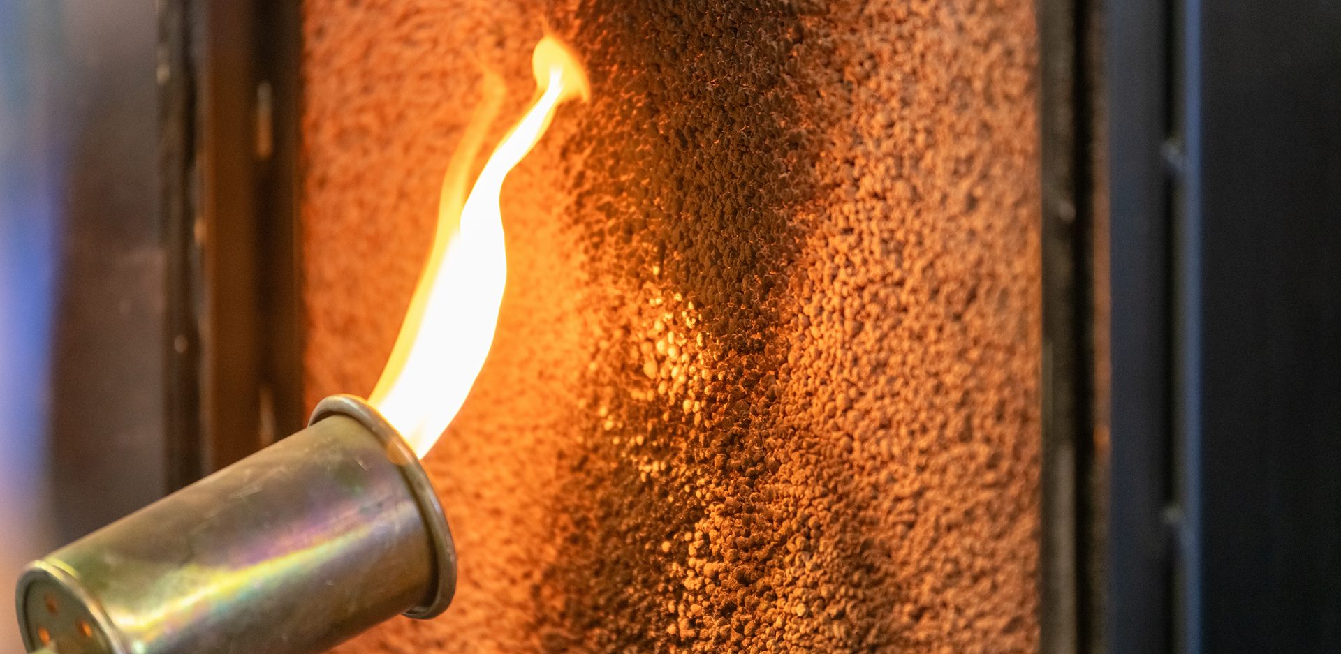 Close up of a flame torch testing flame retardant material, demonstrating fire resistance and safety in industrial applications