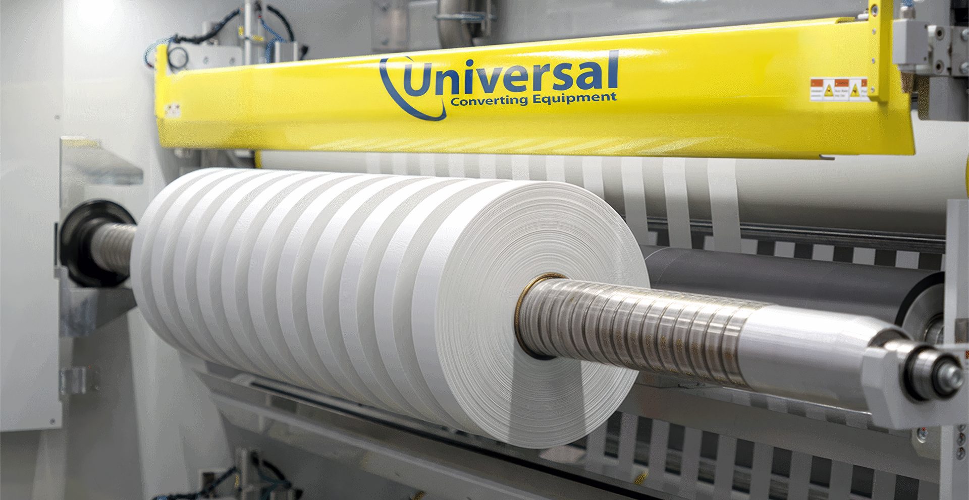 A high-precision demonstration of the Universal X8 performing narrow-web slitting and rewinding on a white substrate.