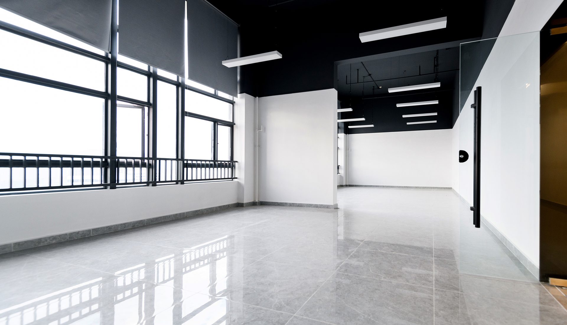 Empty office with glass window and resin coated flooring 