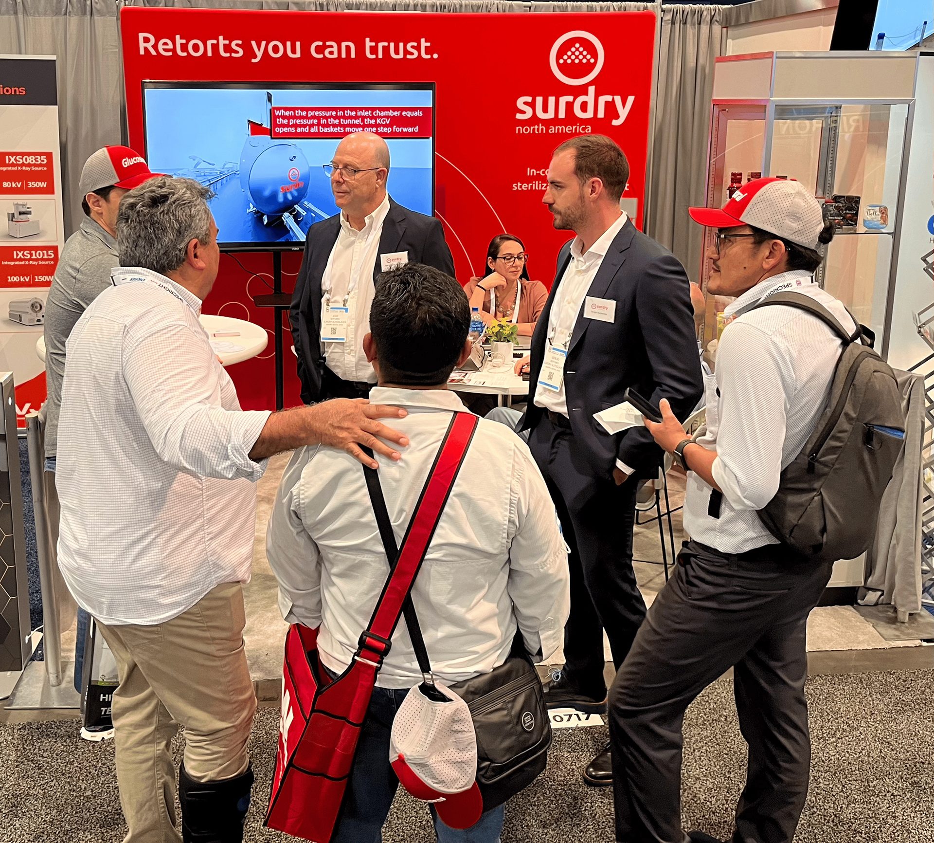 Representatives of Surdry North America presenting retort solutions at a trade show.
