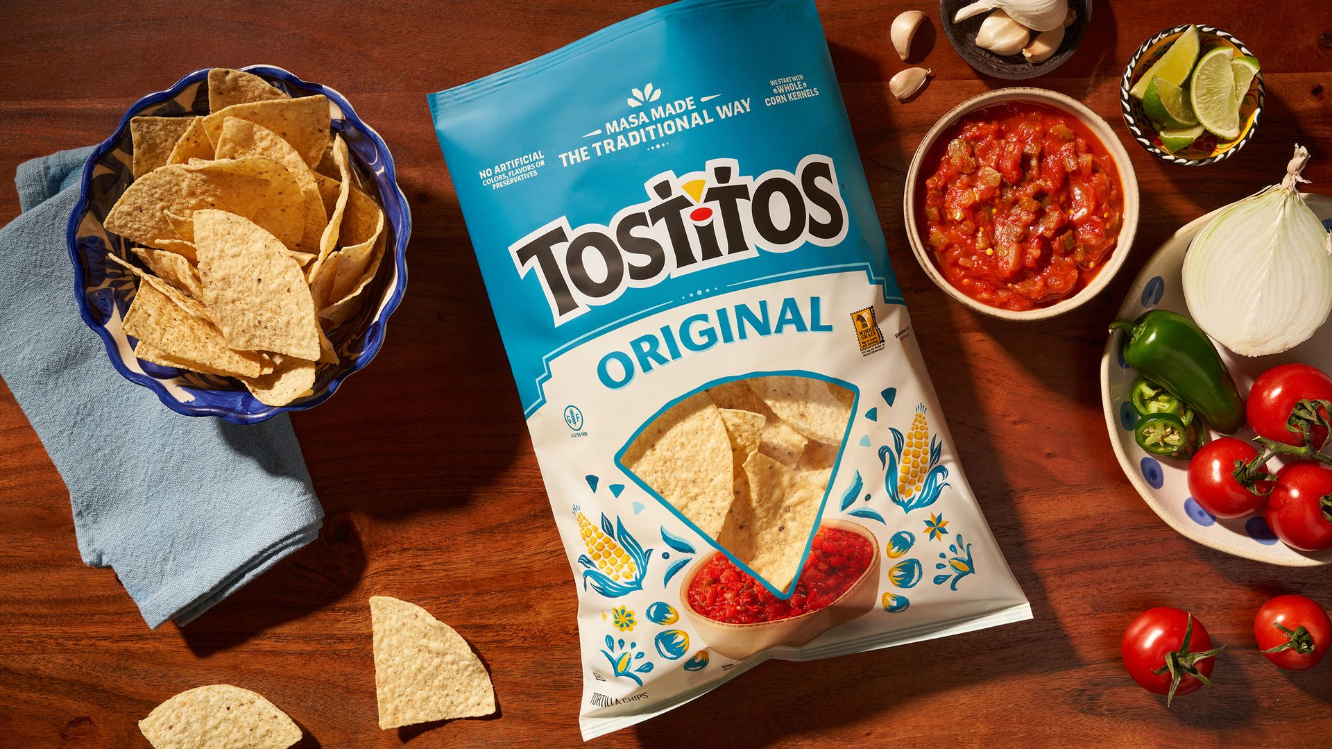 Tostito’s Original new packaging on table with bowl of chips and salsa