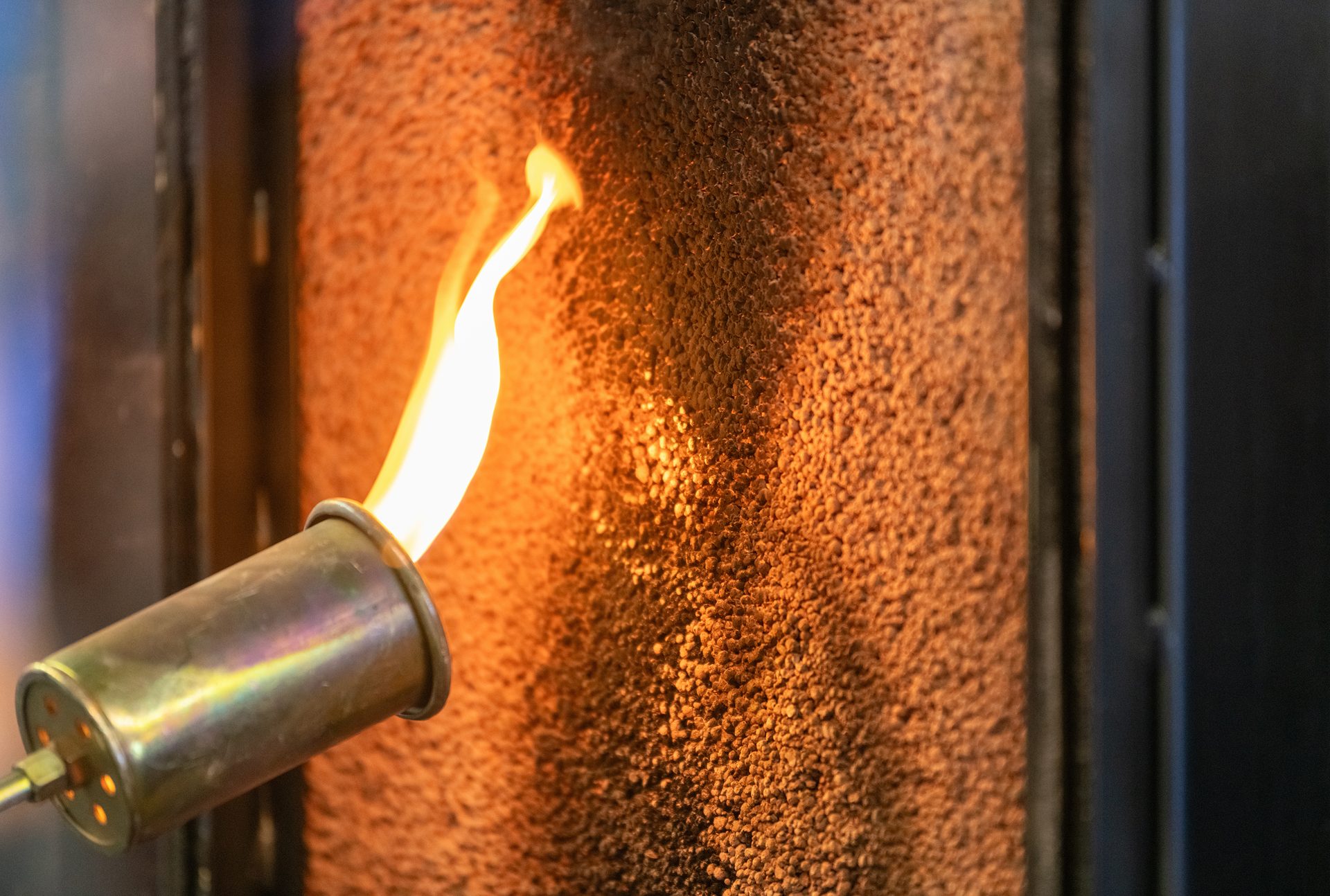 Close up of a flame torch testing flame retardant material, demonstrating fire resistance and safety in industrial applications