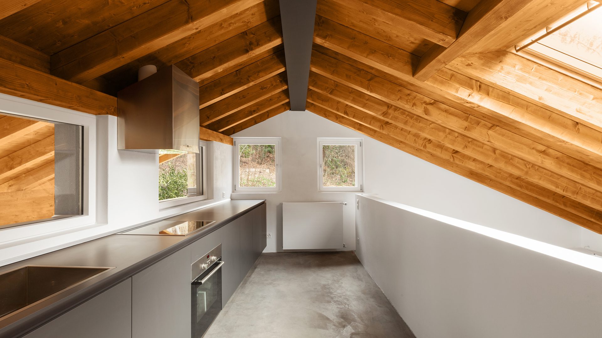 Architecture inside an interiors modern house featuring wooden beams in ceiling and grey resin flooring