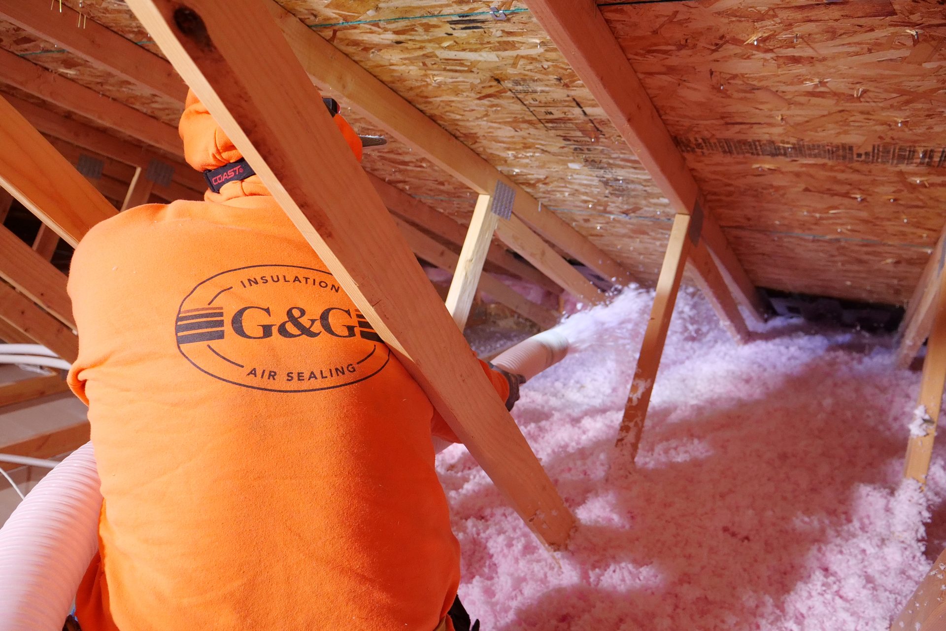G&G Insulation worker installing insulation