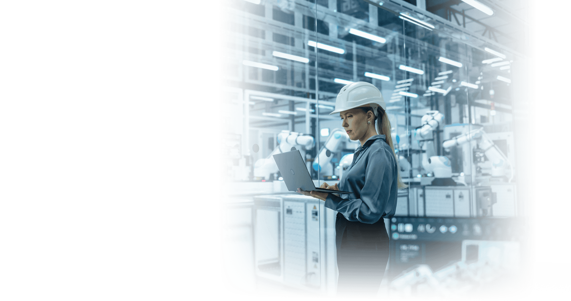 Woman worker using laptop in a modern manufacturing environment