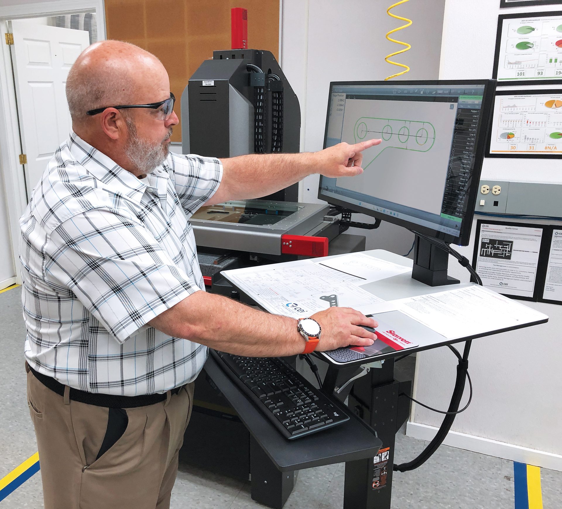 Eric Boyea, CEI Quality Manager, checking the precise profile of stamped “inserts”. 