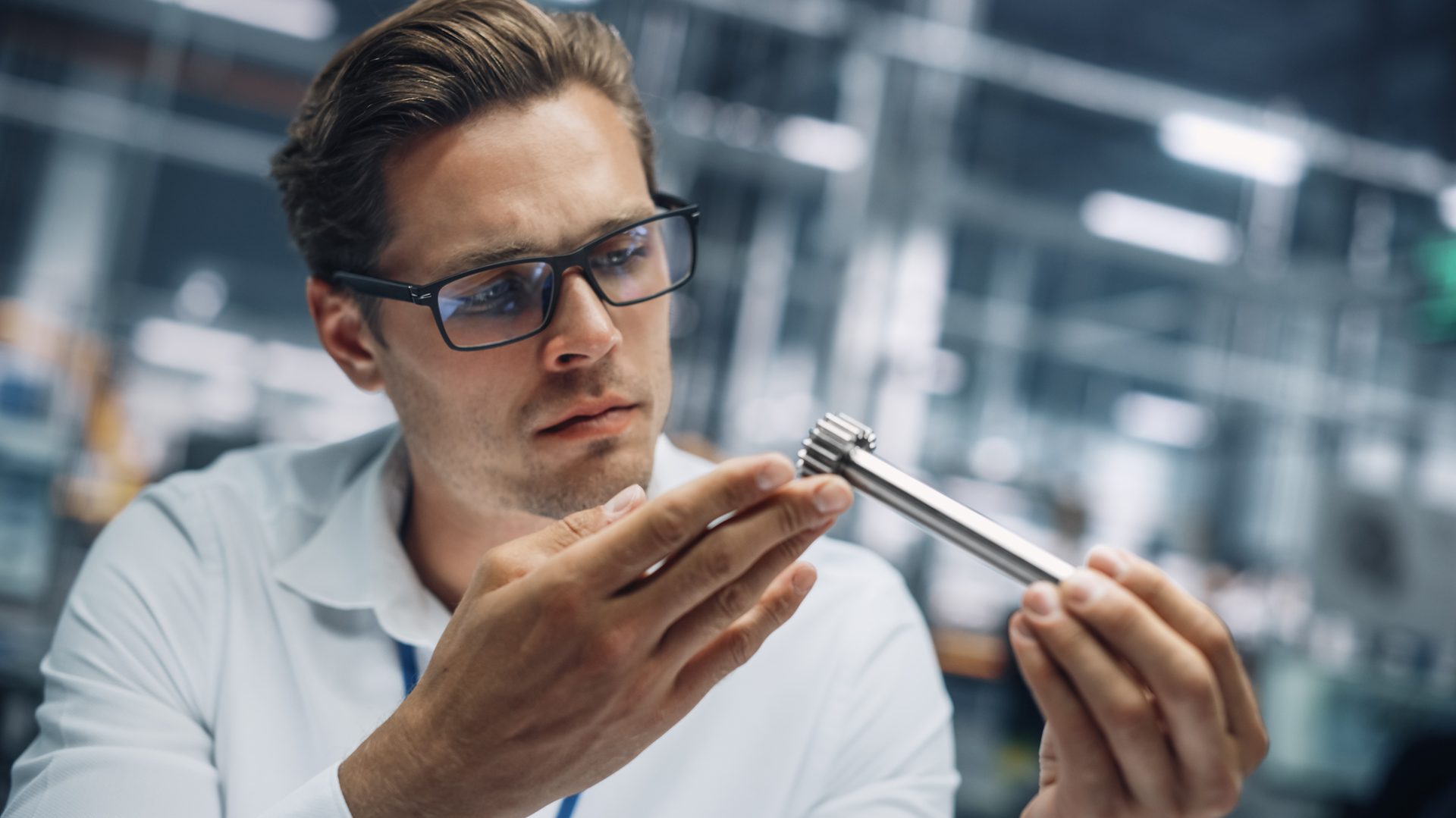 worker inspecting a machined part