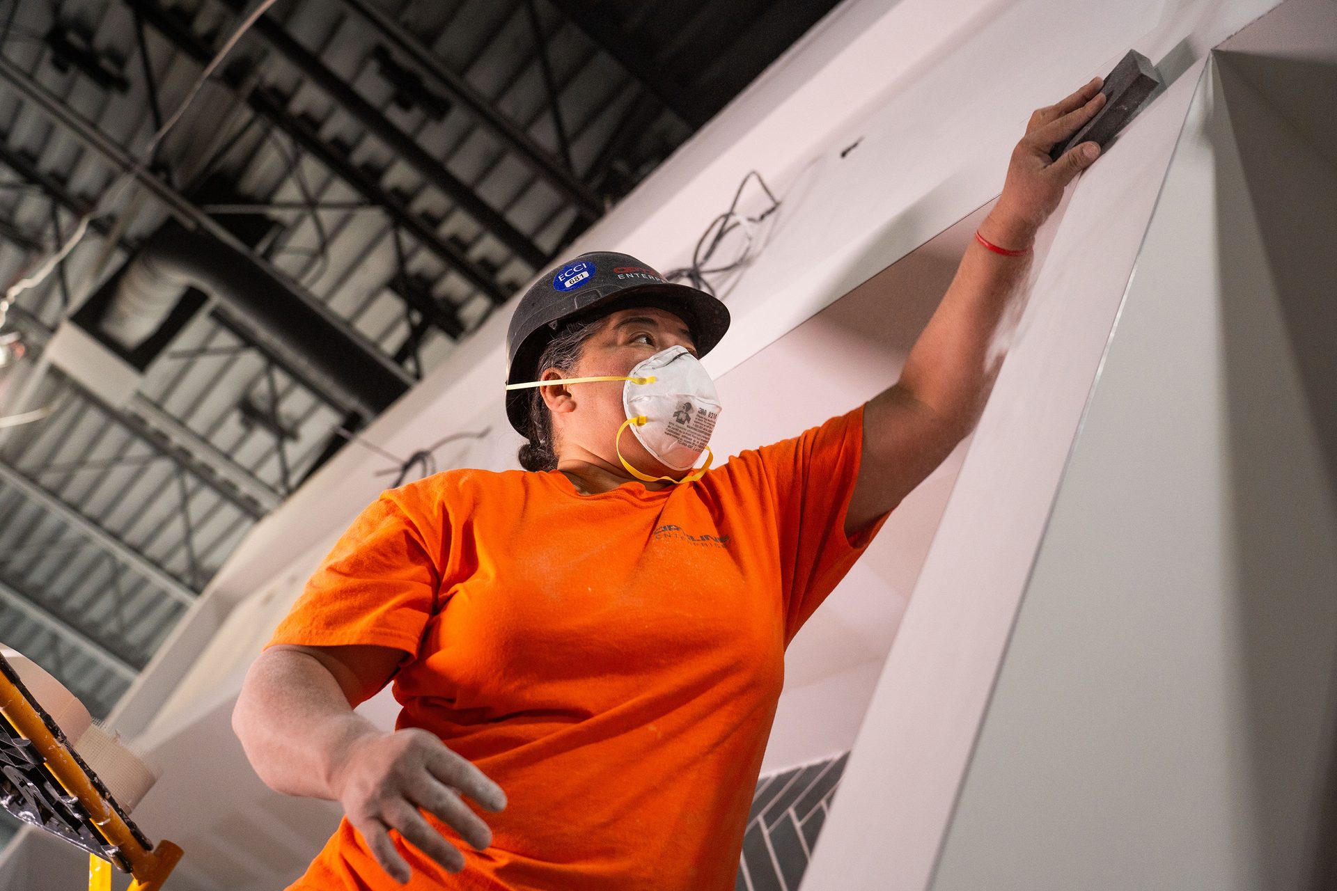 worker sanding drywall