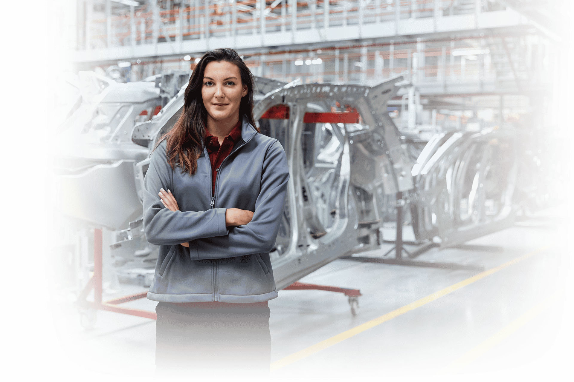 woman worker standing in auto manufacturing plant