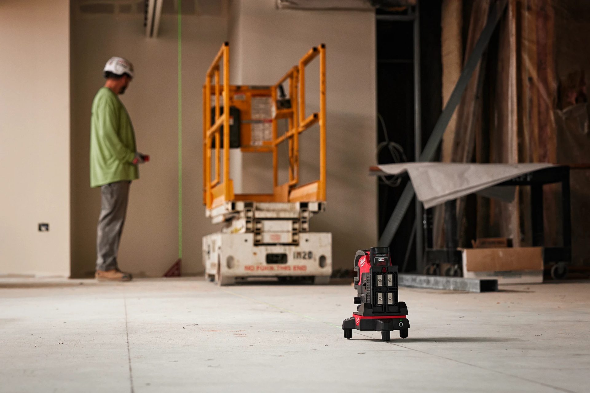 Worker using laser alignment tool
