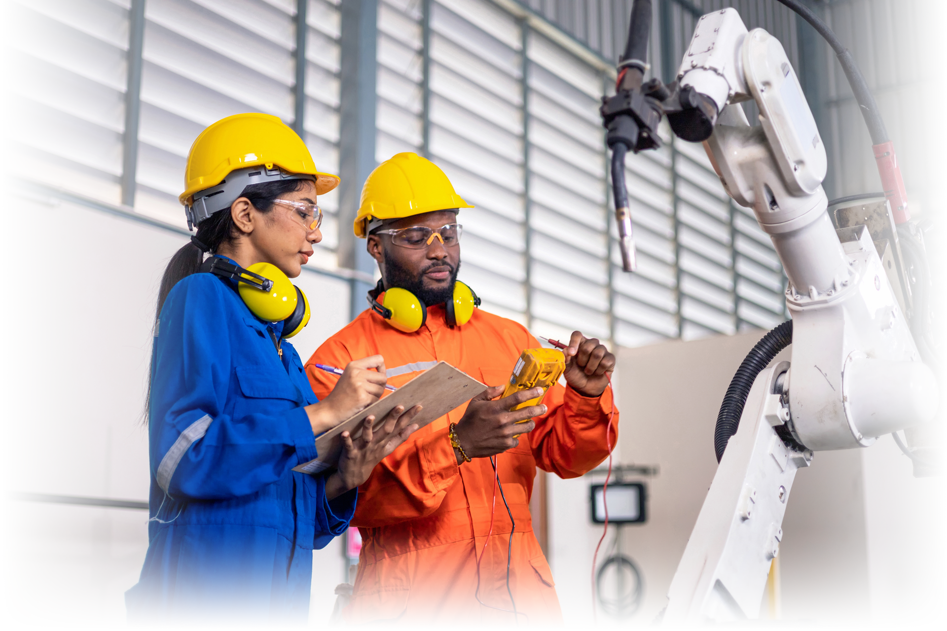 Two factory workers with robotic arm