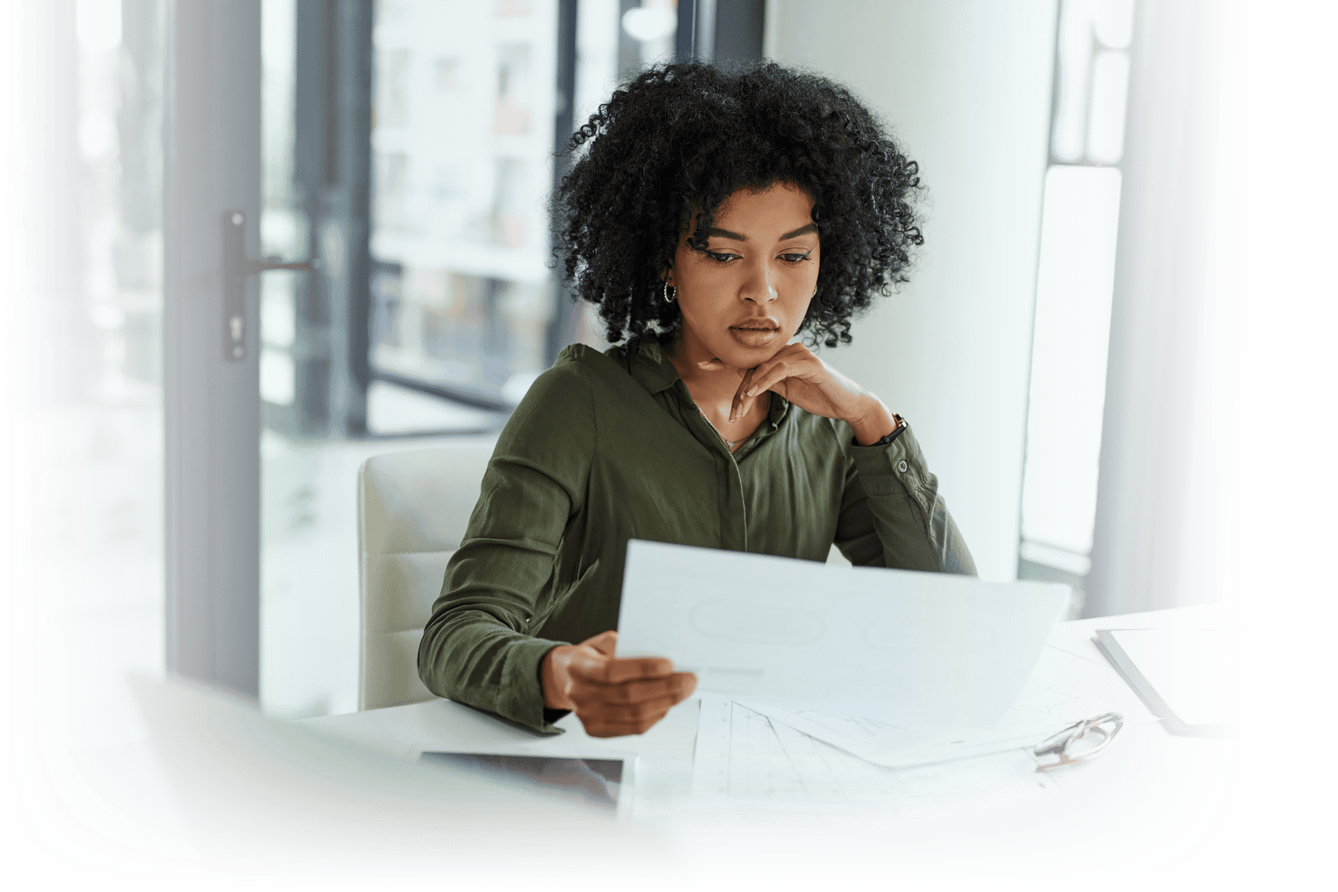 Woman at desk looking over paperwork