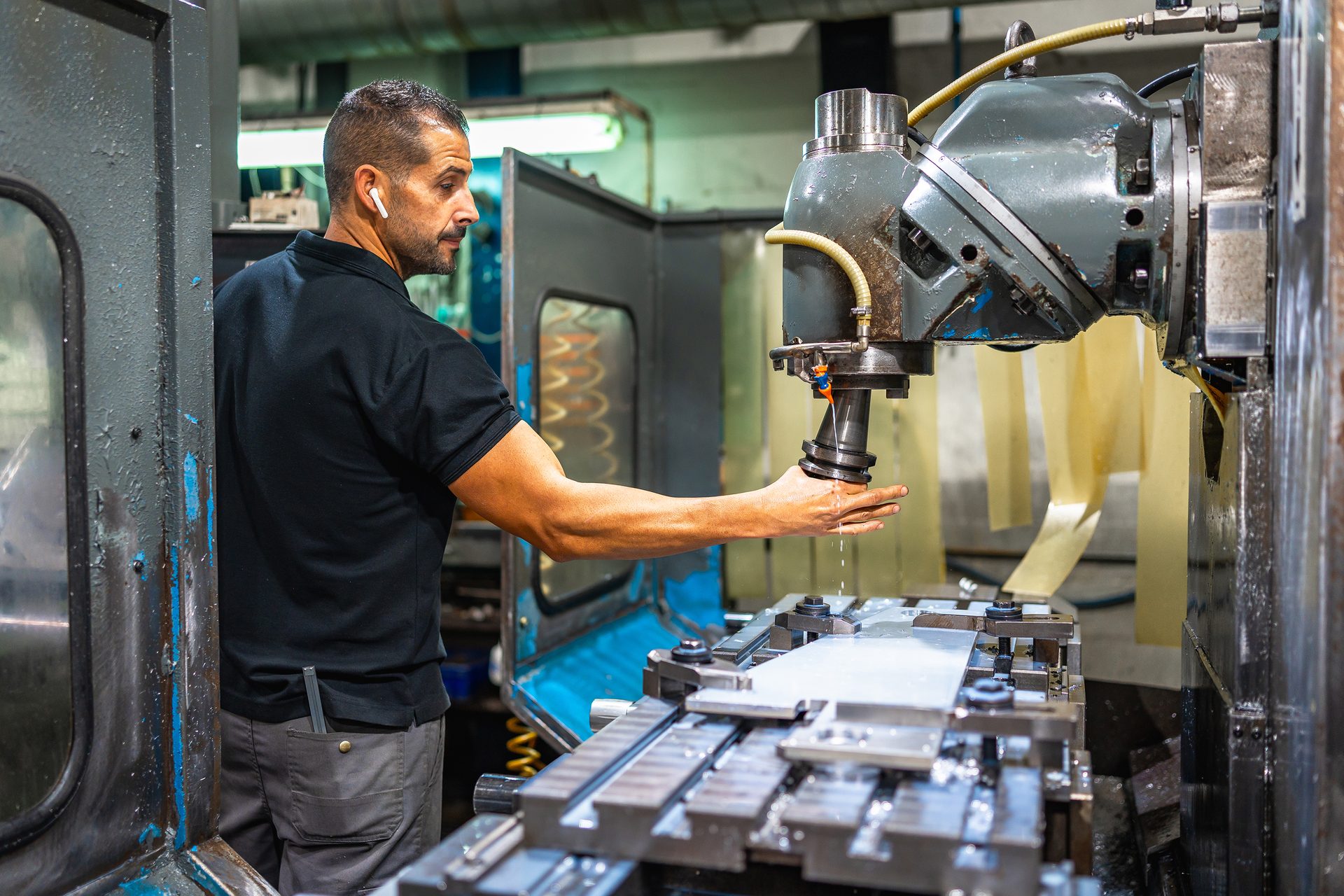 Factory worker adjusting machine