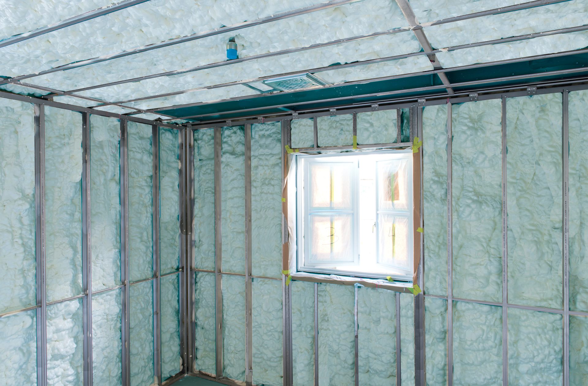 Interior room framing and insulation with window.