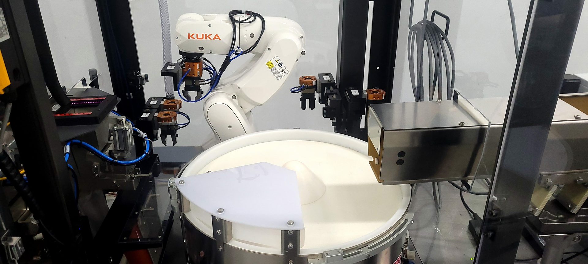Using custom designed end-of-arm tooling (EOAT) on an automatic tool changer, this flexible vision-guided robot system can handle part sizes ranging from 0.1mm in diameter up to 100 x 30 x 30. 