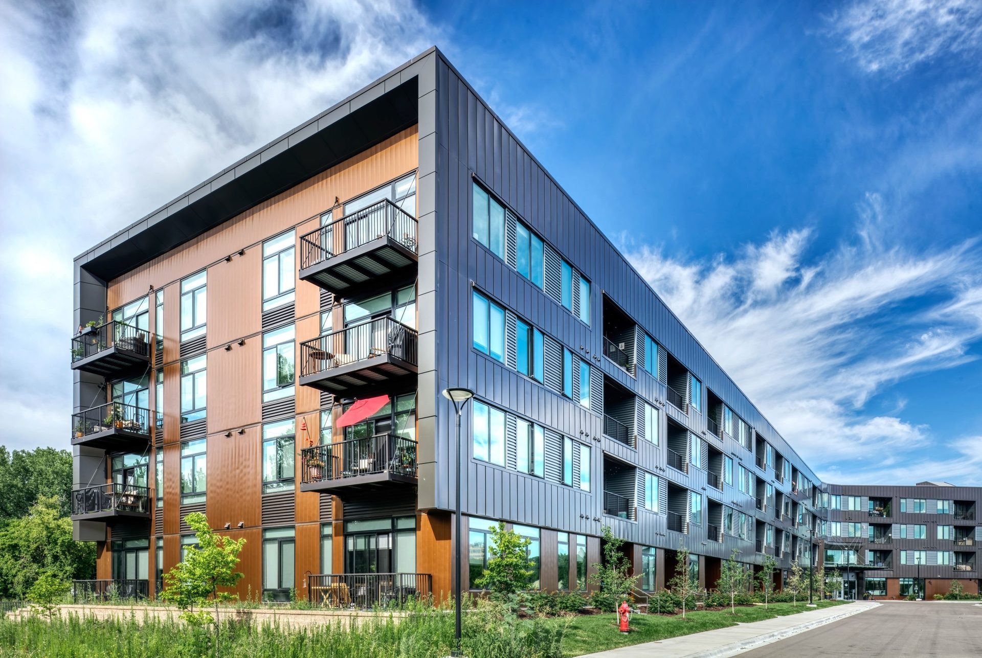 New Metal-Clad Apartment Complex Brings Public Access to Riverfront