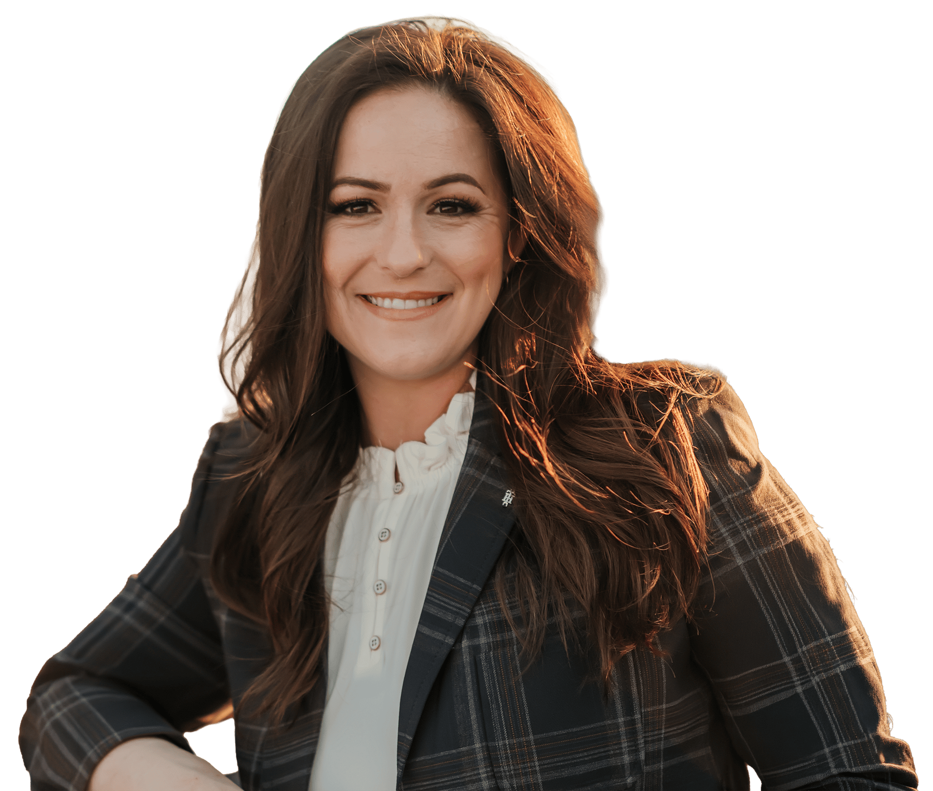 A smiling woman with long brown hair wearing a plaid blazer and white ruffled shirt, looking directly at the camera.