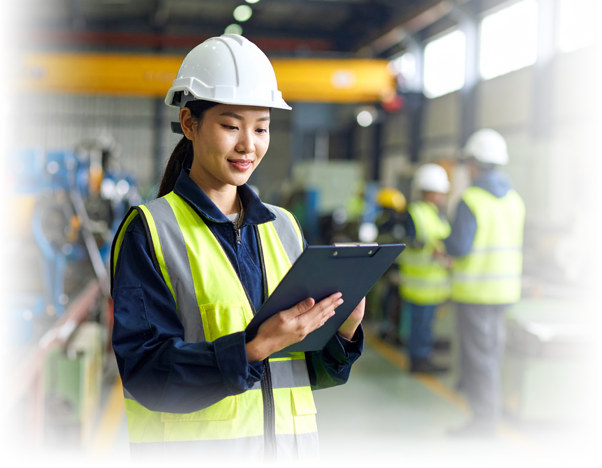 Female worker with clipboard in a factory environment