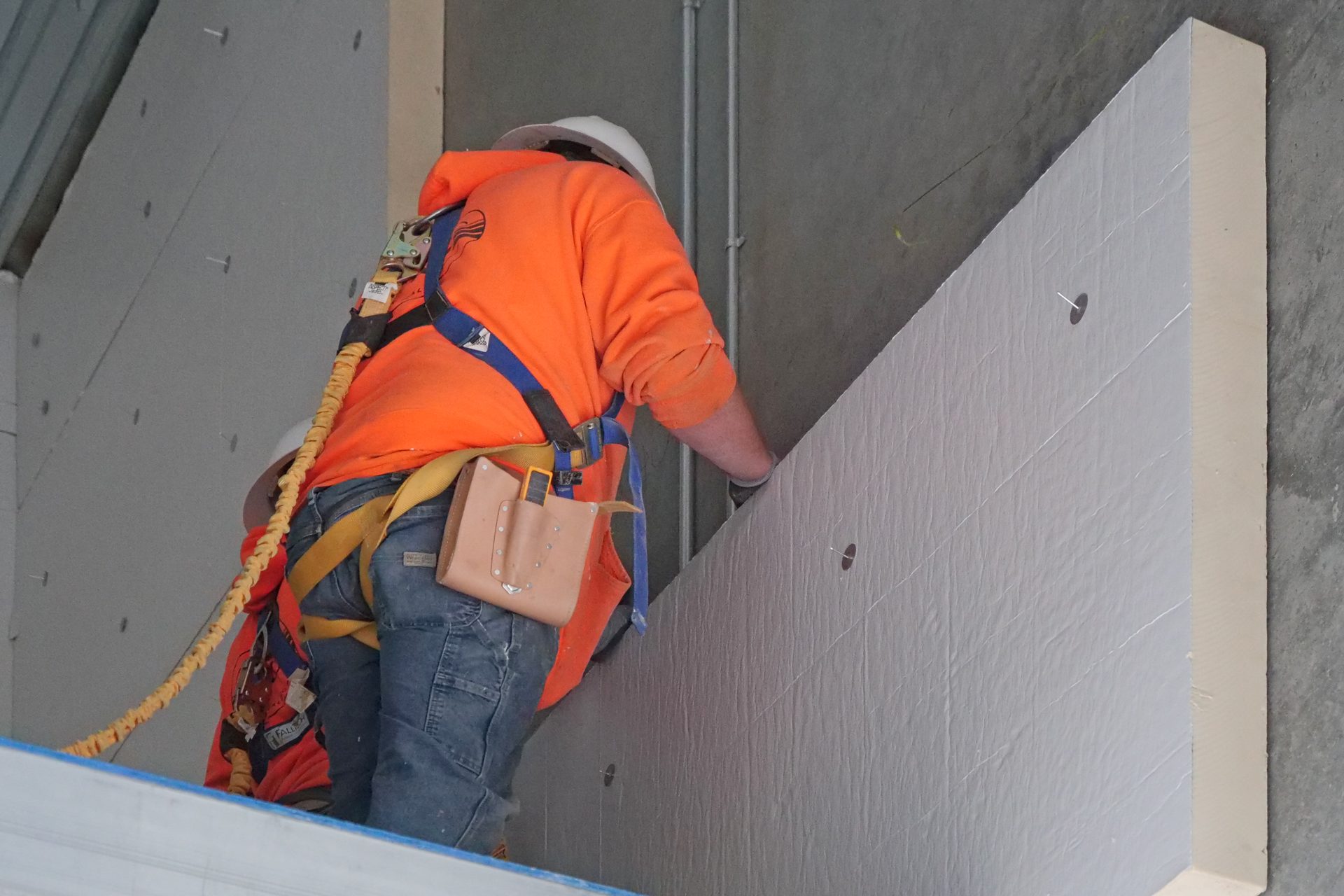 G&G Insulation workers installing insulation panel