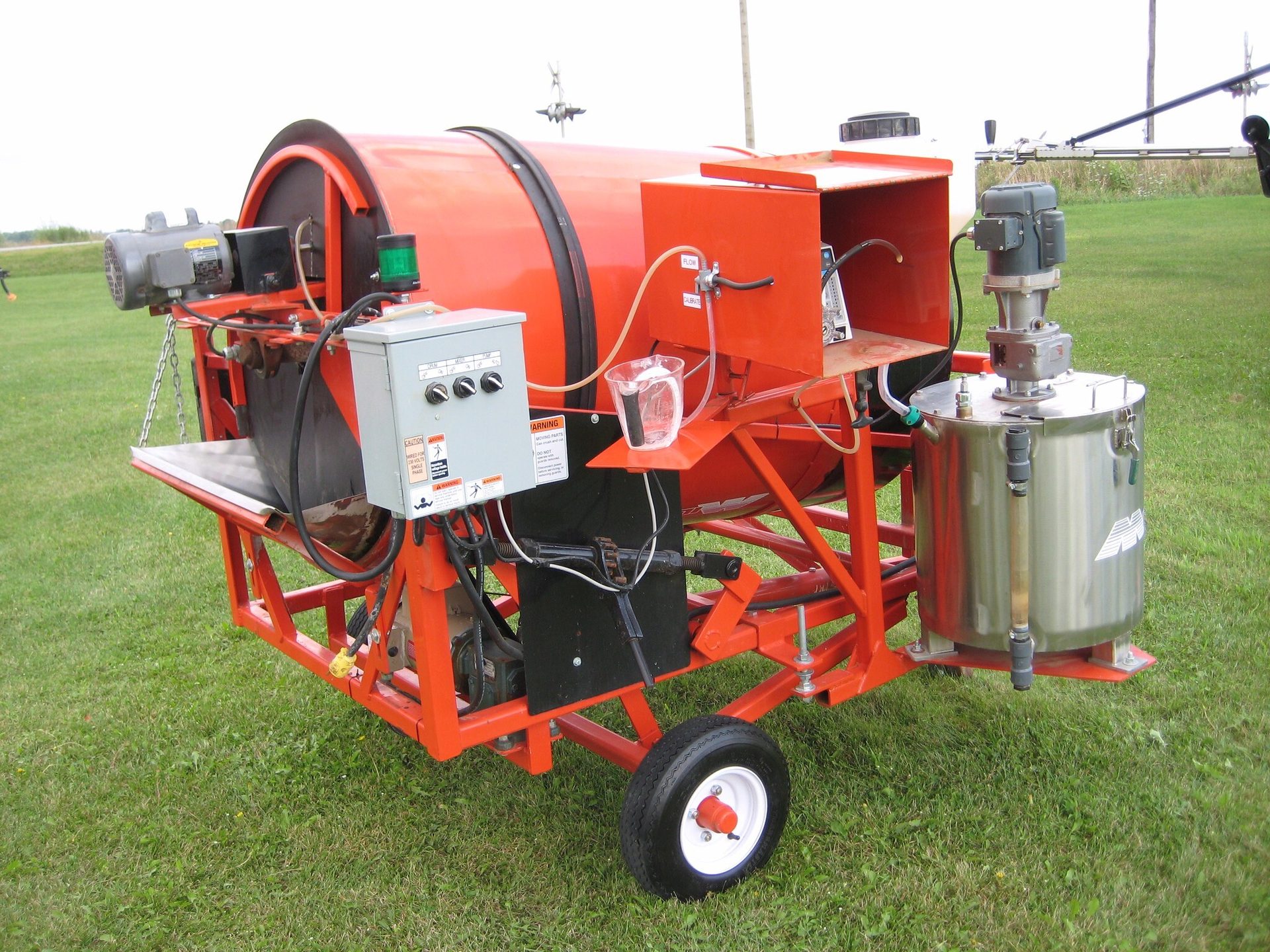 Potato planter showcasing nozzles used to apply solutions in-furrow during planting