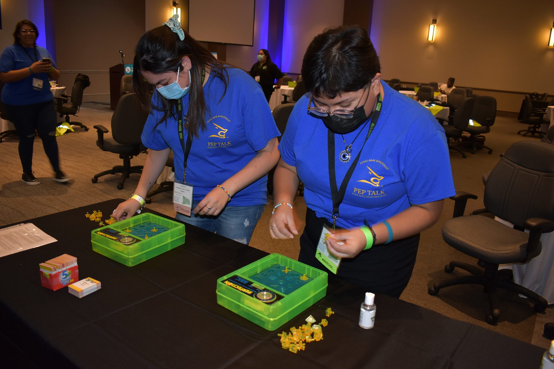 Two students playing the game perfection at event