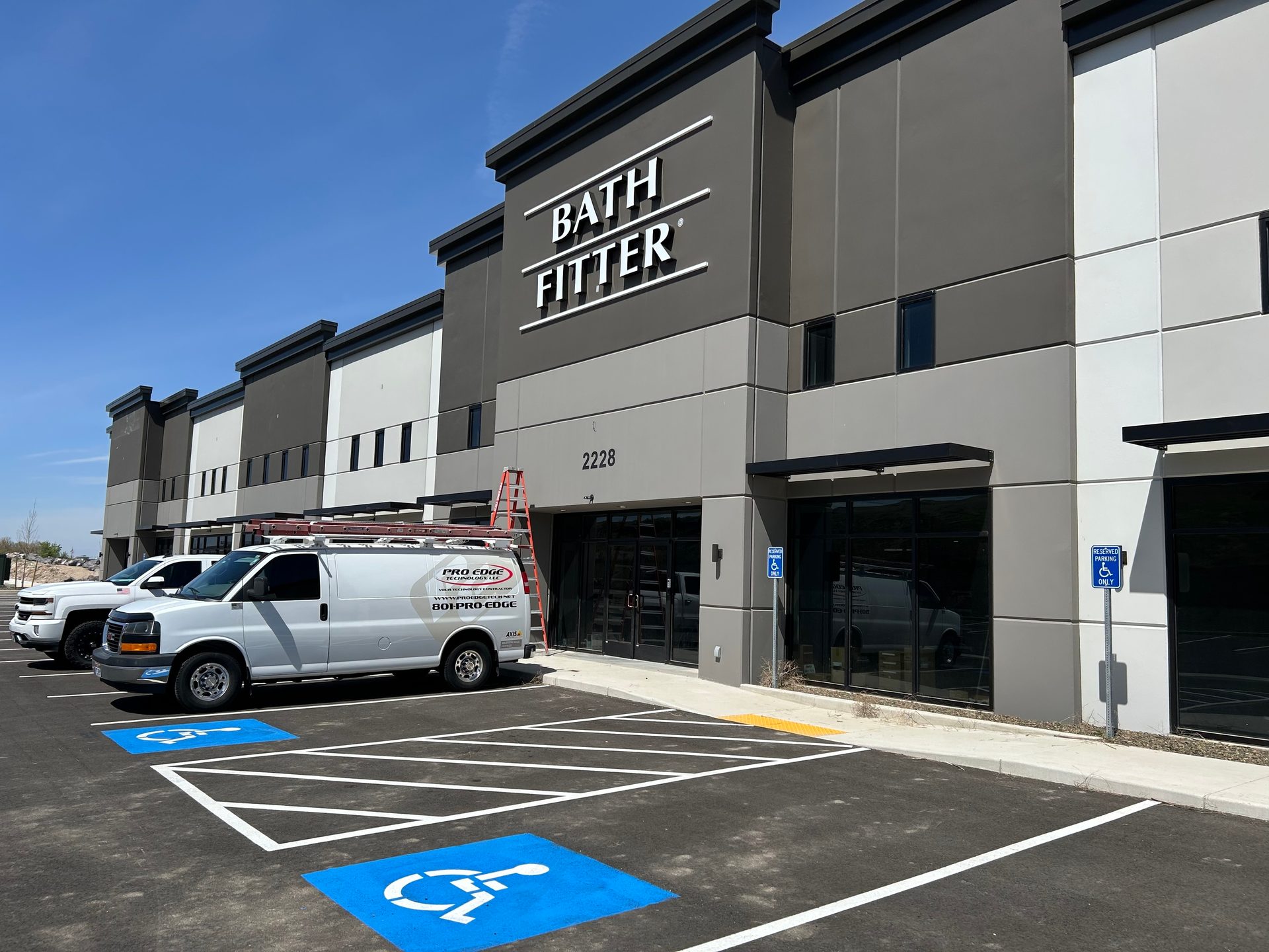Bath Fitter building exterior with a white van and accessible parking spaces.