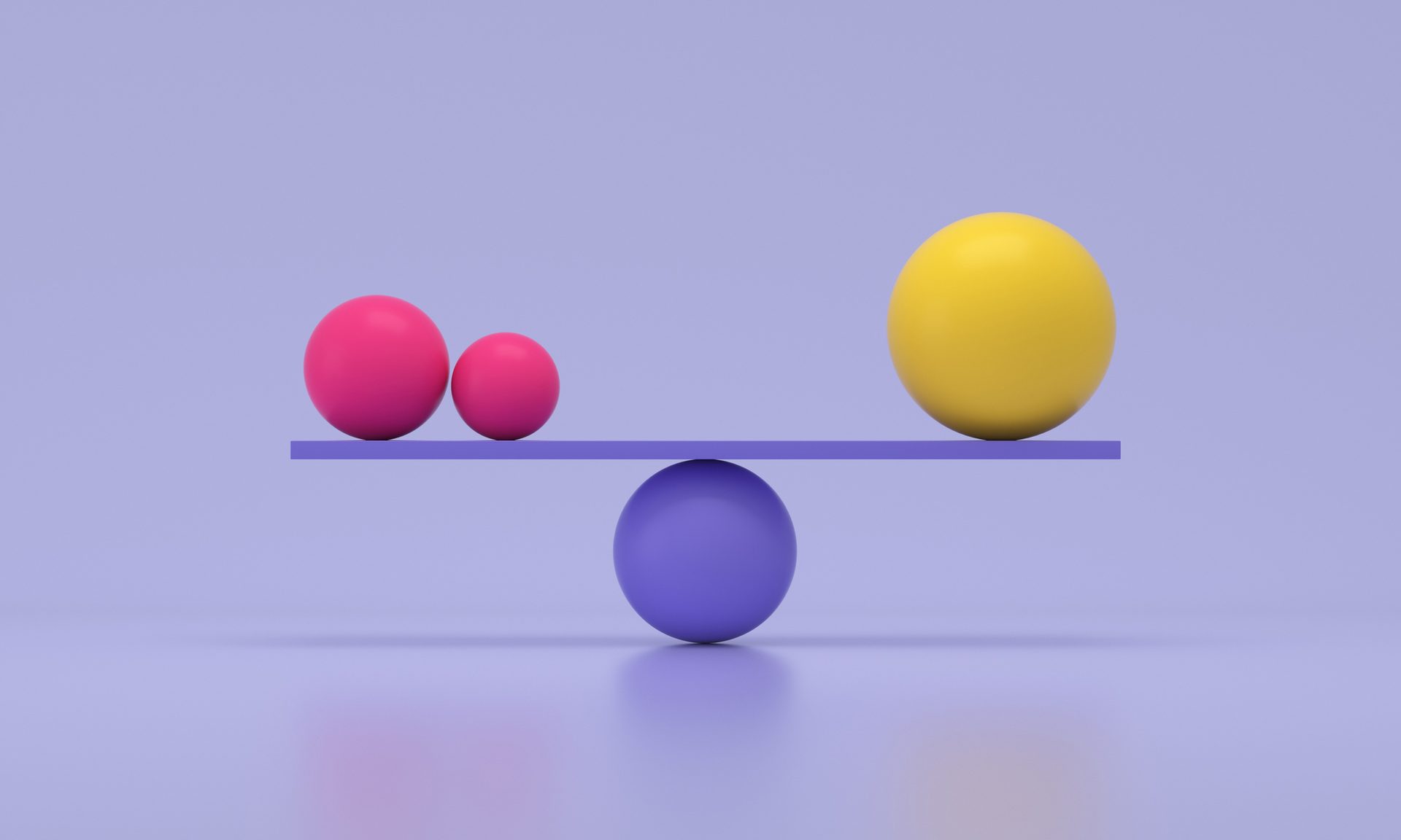 Two pink balls and a yellow ball balanced on a purple seesaw.