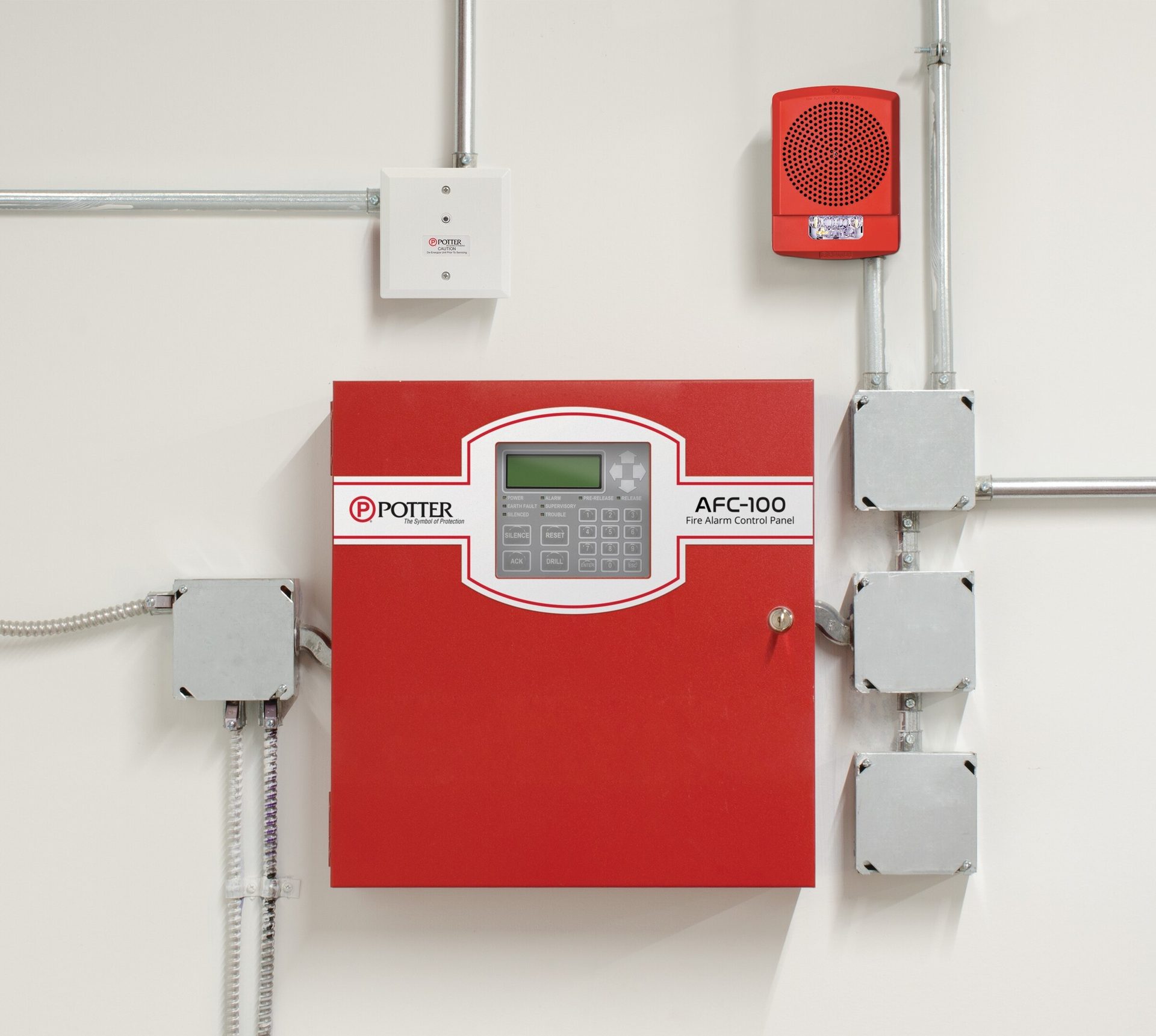 A red Potter AFC-100 fire alarm control panel with a speaker, junction boxes, and conduits on a white wall.