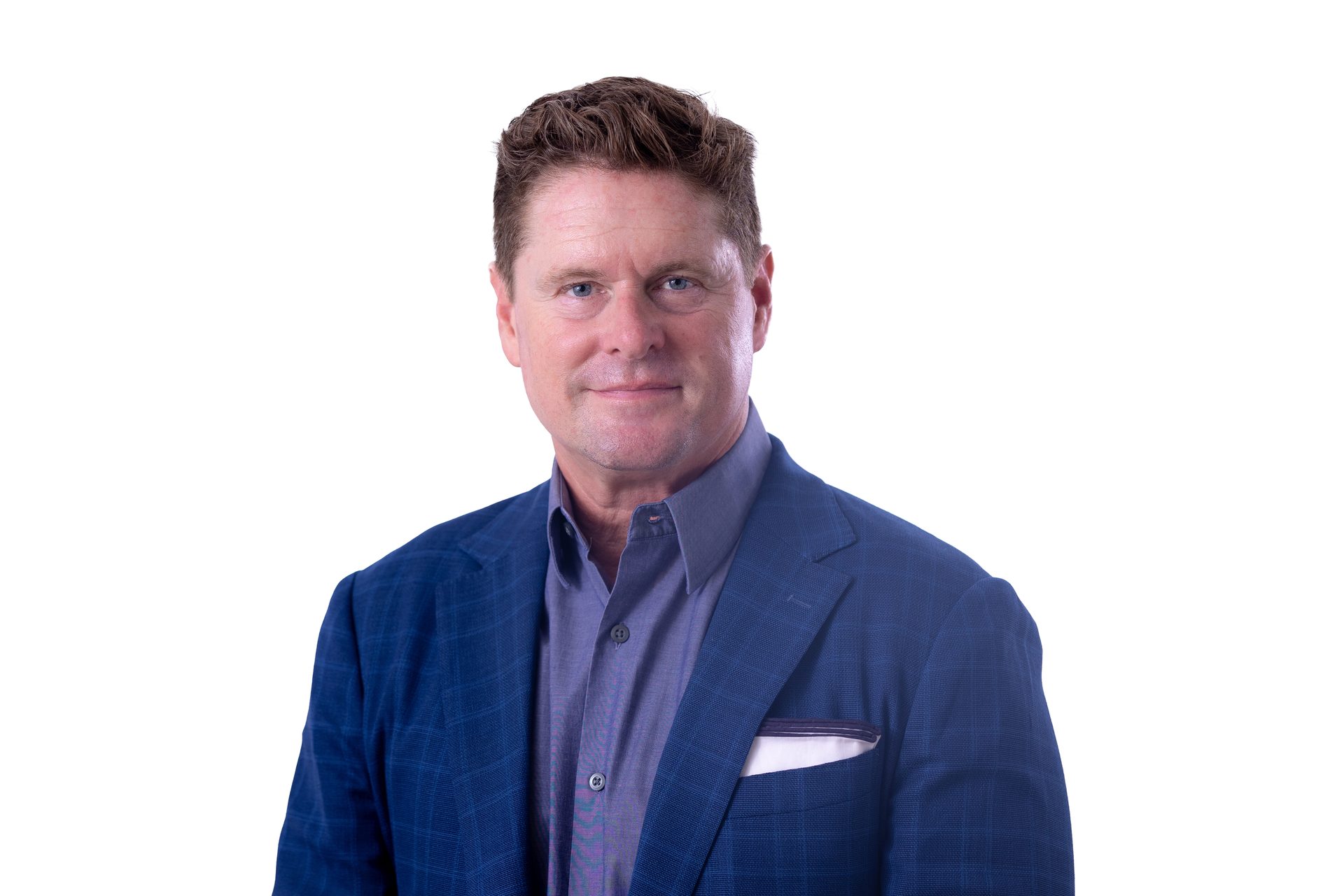 A man in a blue plaid suit jacket and purple shirt looking at the camera.