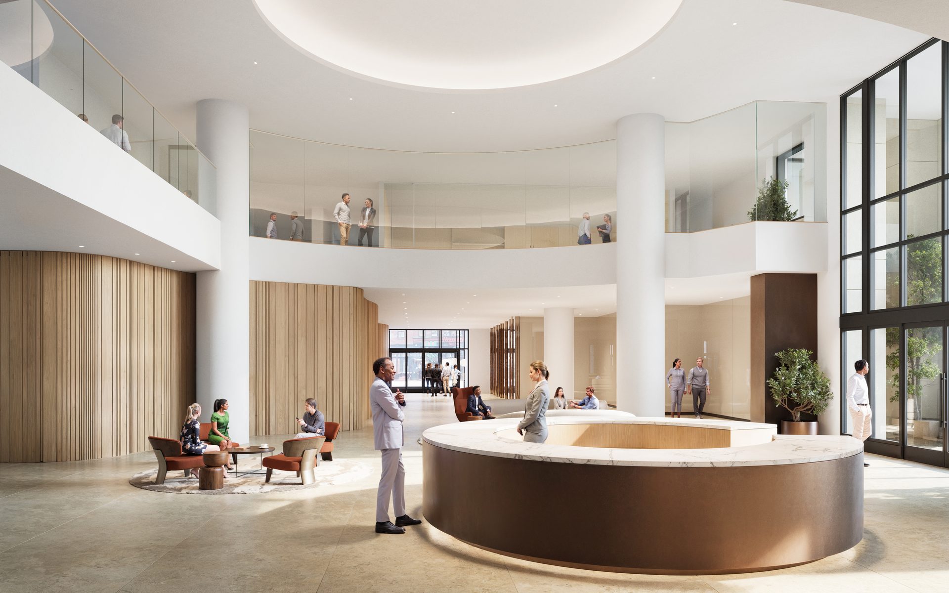 A modern, multi-level lobby with a circular reception desk, people on both floors, and natural light.