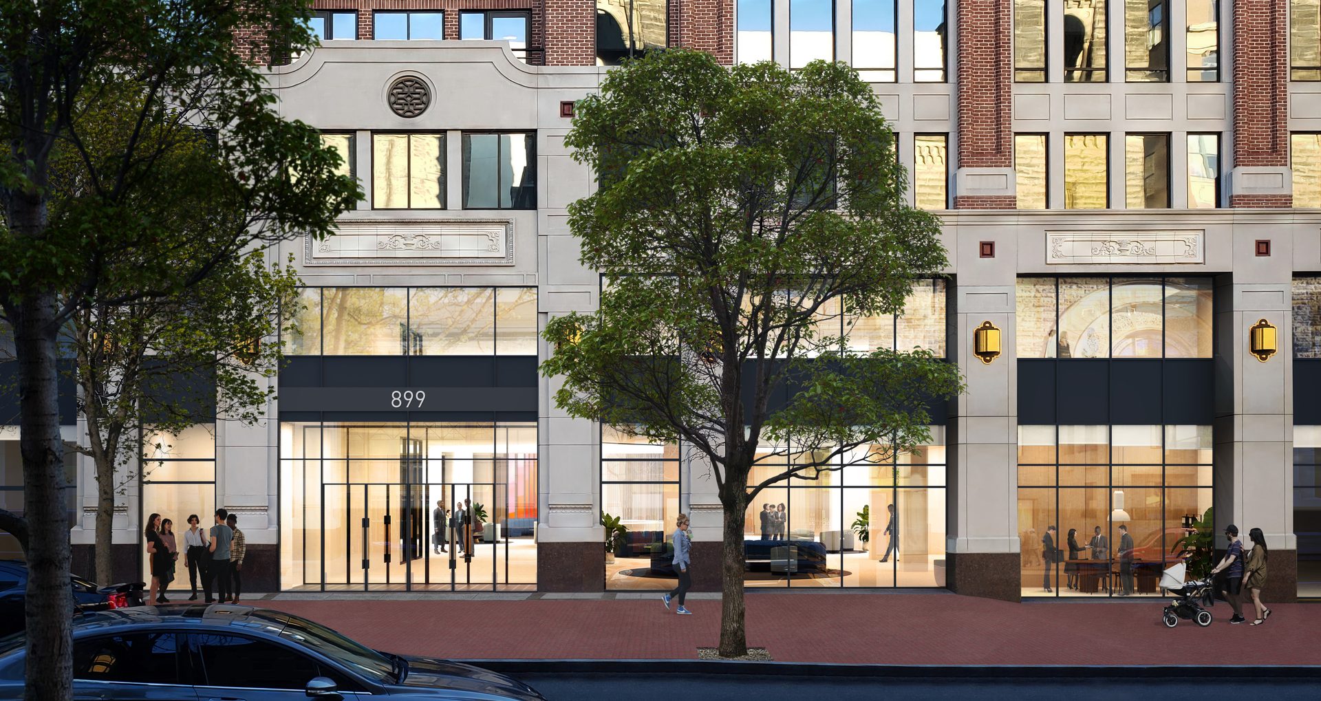 Street scene with building facade 899, large windows, street trees, and people walking on the sidewalk.