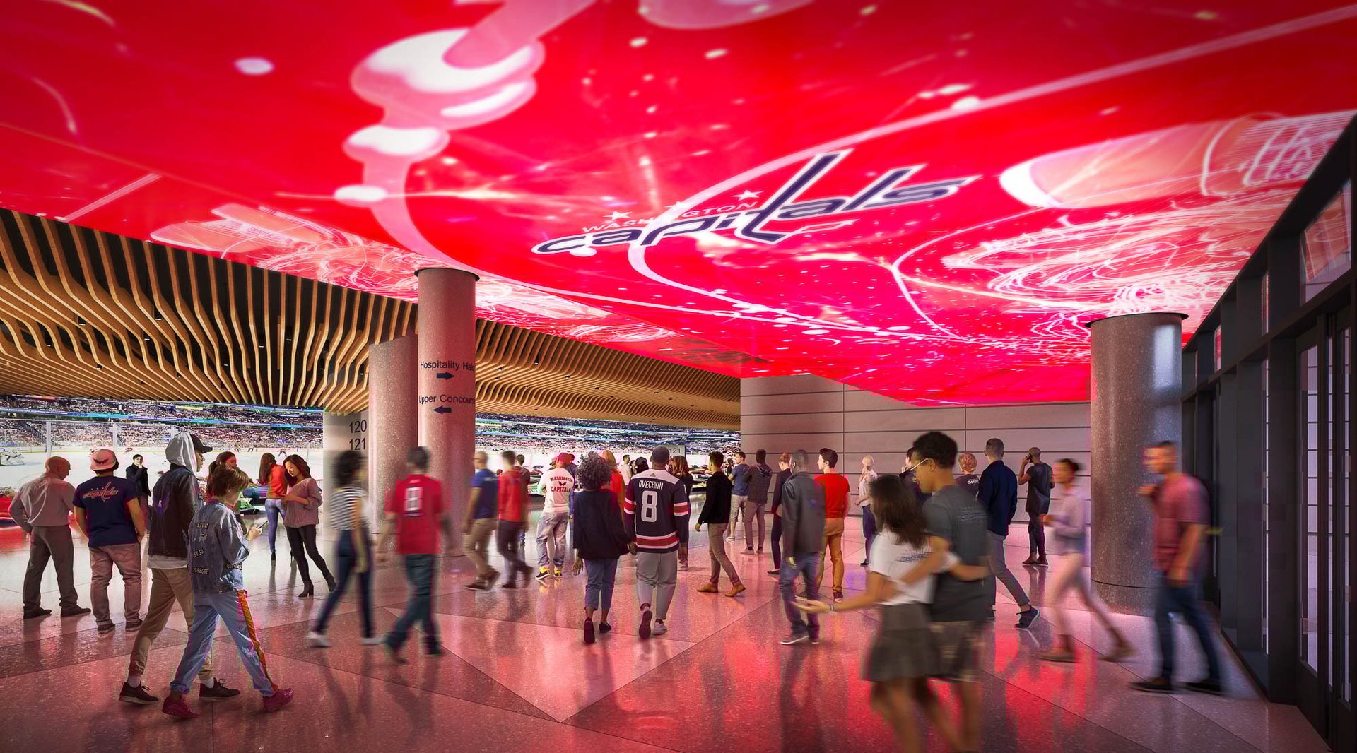 Arena concourse filled with fans, featuring a vibrant red ceiling displaying the Washington Capitals logo.