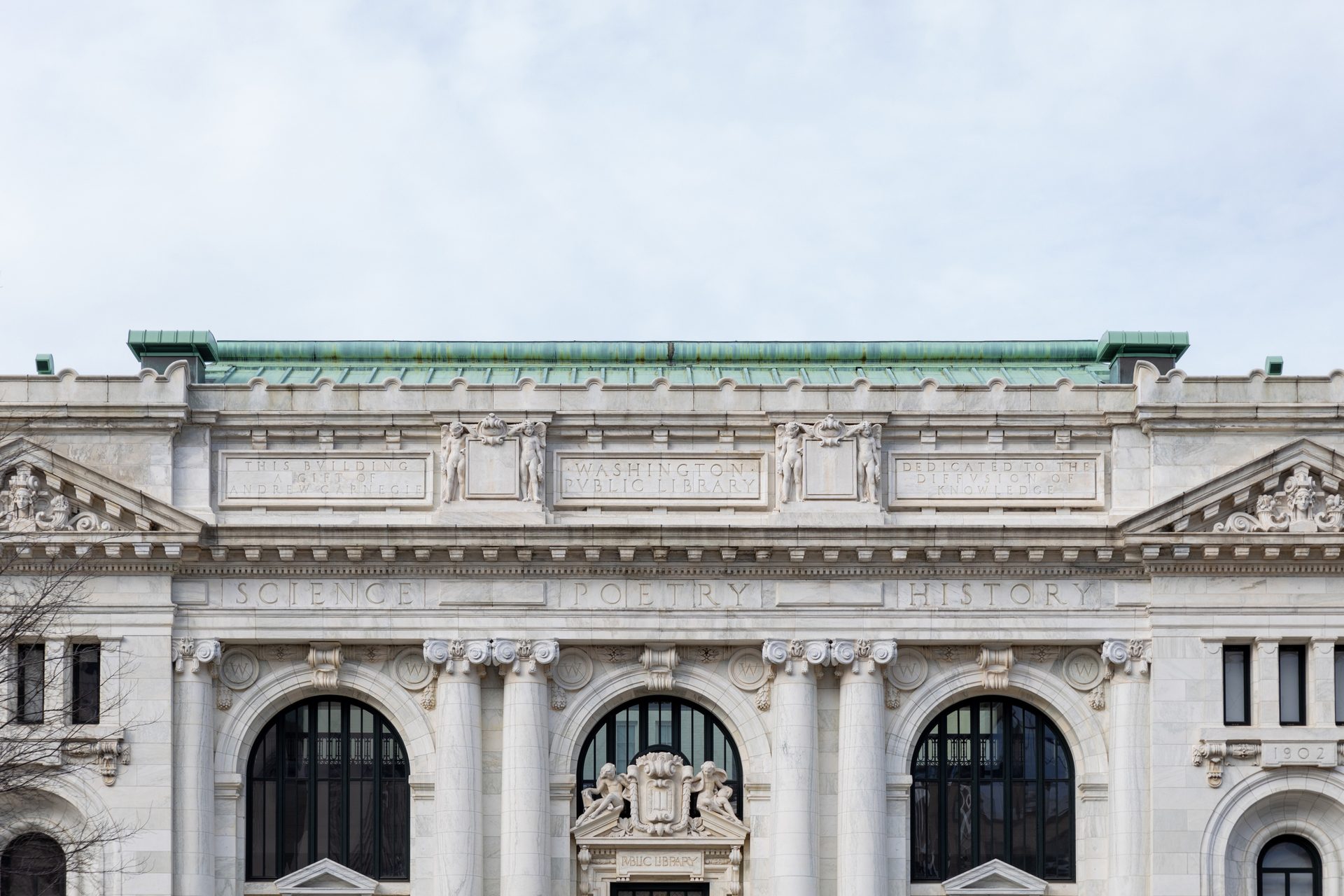 Ornate facade of the Washington Public Library, featuring "SCIENCE," "POETRY," and "HISTORY" inscriptions.