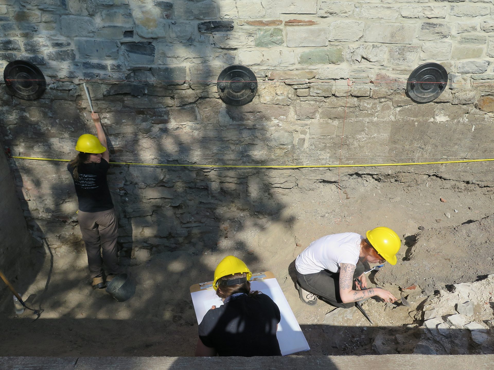 Hard hat, Road surface, Infrastructure, Human, Helmet, Asphalt, Yellow, Headgear, Tradesman, Wall