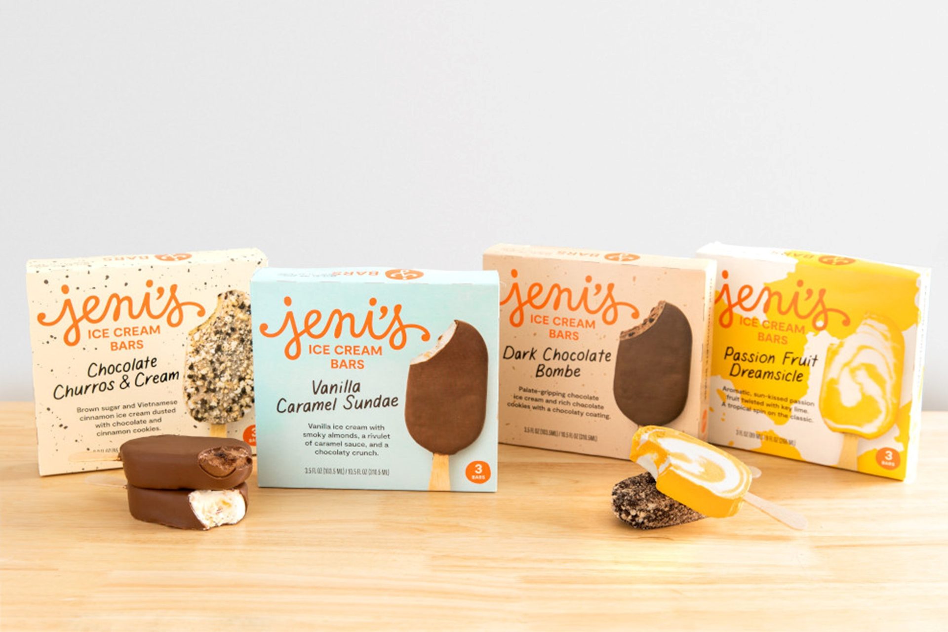 Four Jeni's Ice Cream Bar boxes and bars: Churros, Vanilla, Dark Chocolate, Passion Fruit.