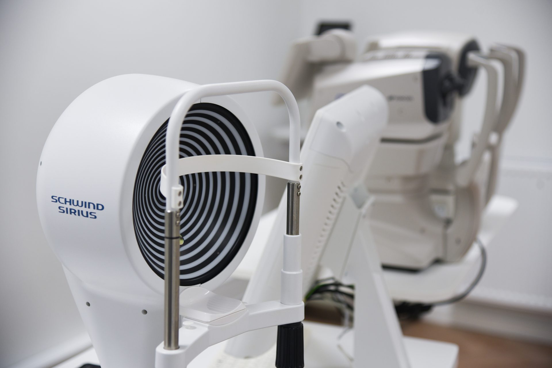 White Schwind Sirius eye examination machine with a black and white spiral.