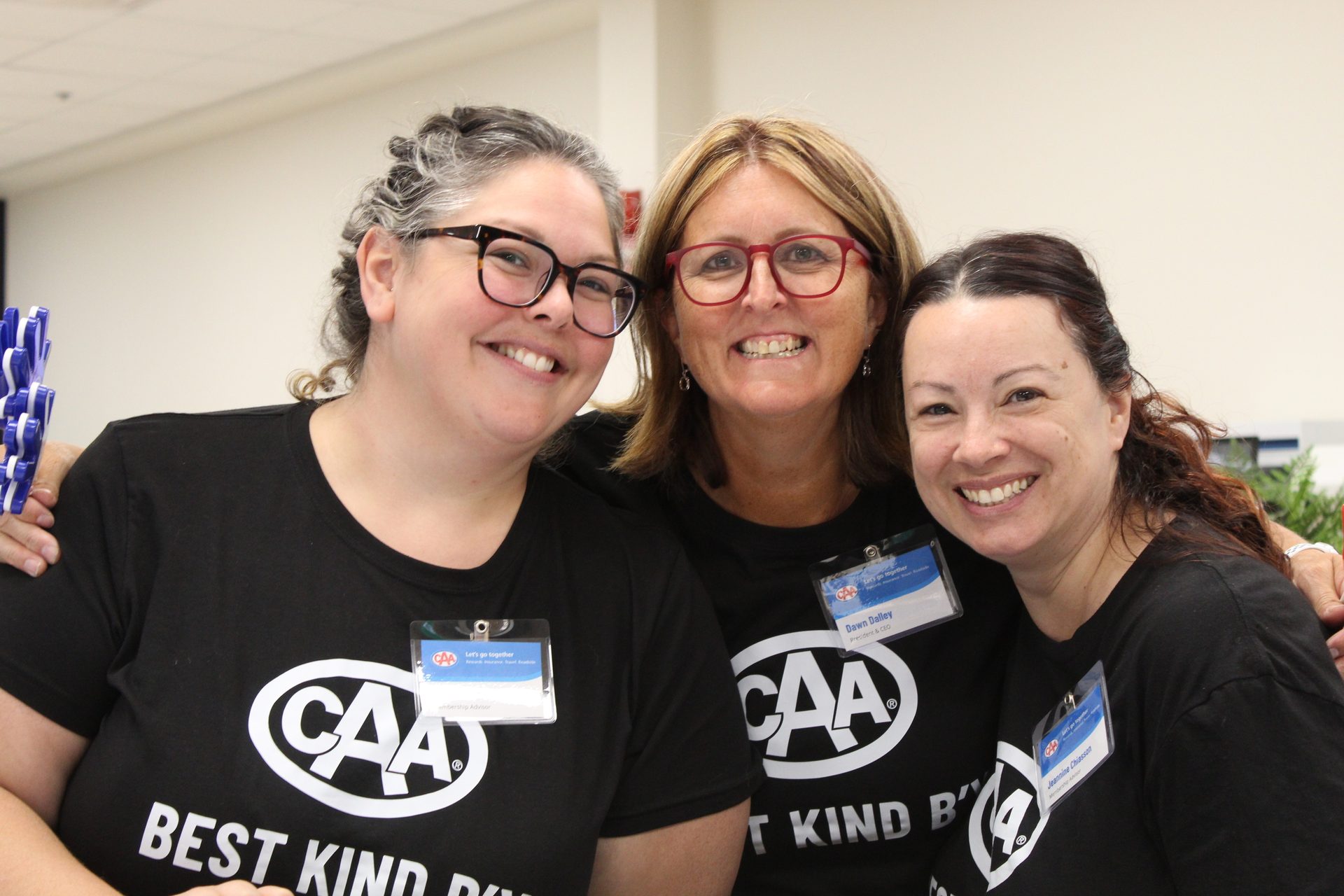 Three smiling women in black CAA t-shirts, one identified as President & CEO.