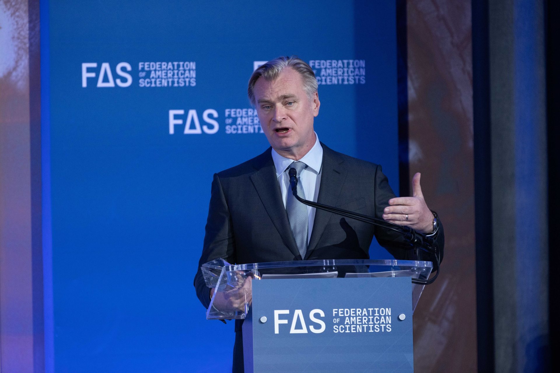 Christopher Nolan speaking at a podium with the Federation of American Scientists logo.