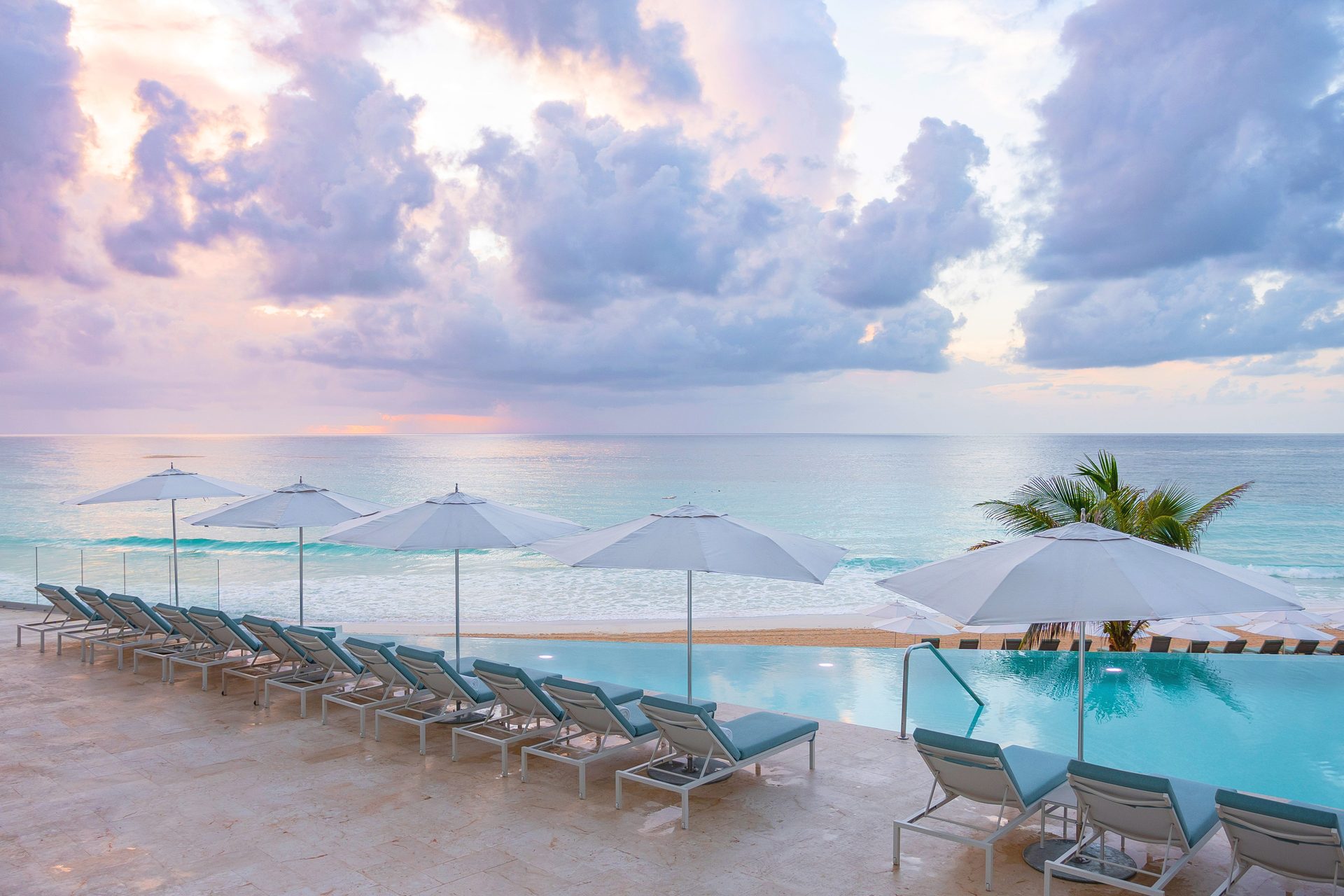 Coastal and oceanic landforms, Natural environment, Outdoor furniture, Cloud, Water, Sky, Umbrella, Blue, Azure, Shade