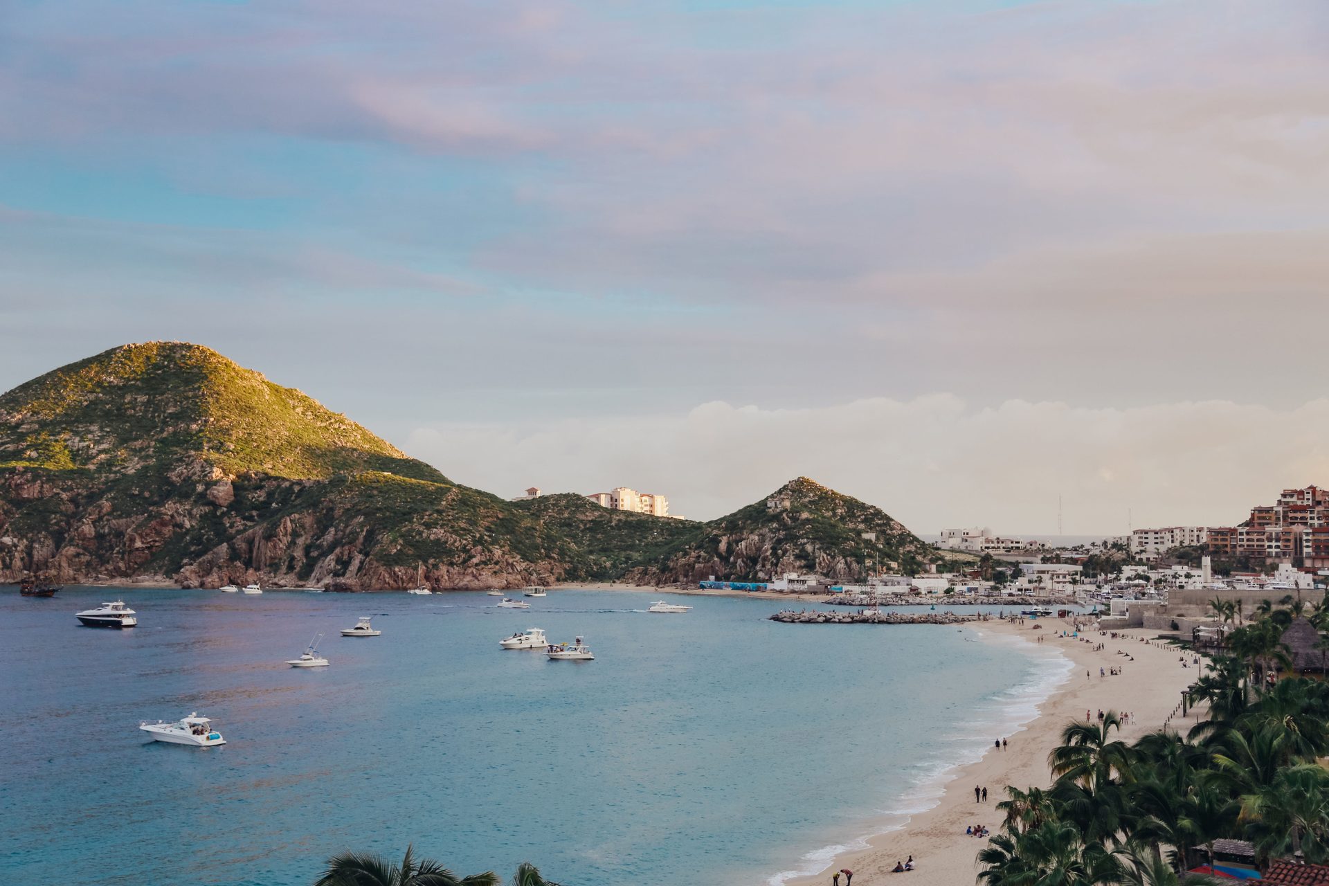 Coastal and oceanic landforms, Water, Cloud, Sky, Boat, Mountain, Watercraft, Beach, Travel, Tree