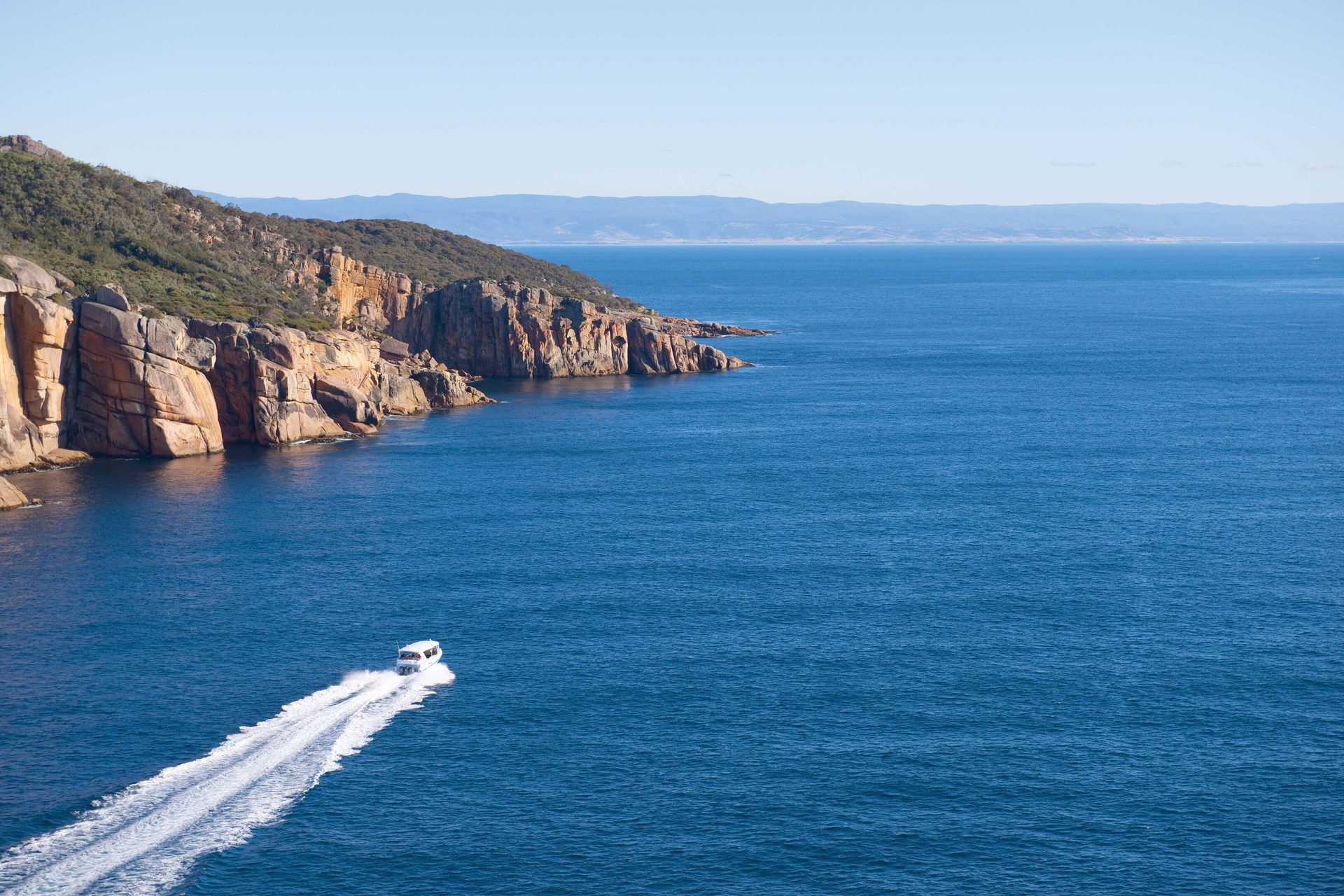 Coastal and oceanic landforms, Natural landscape, Water, Sky, Azure, Boat, Mountain