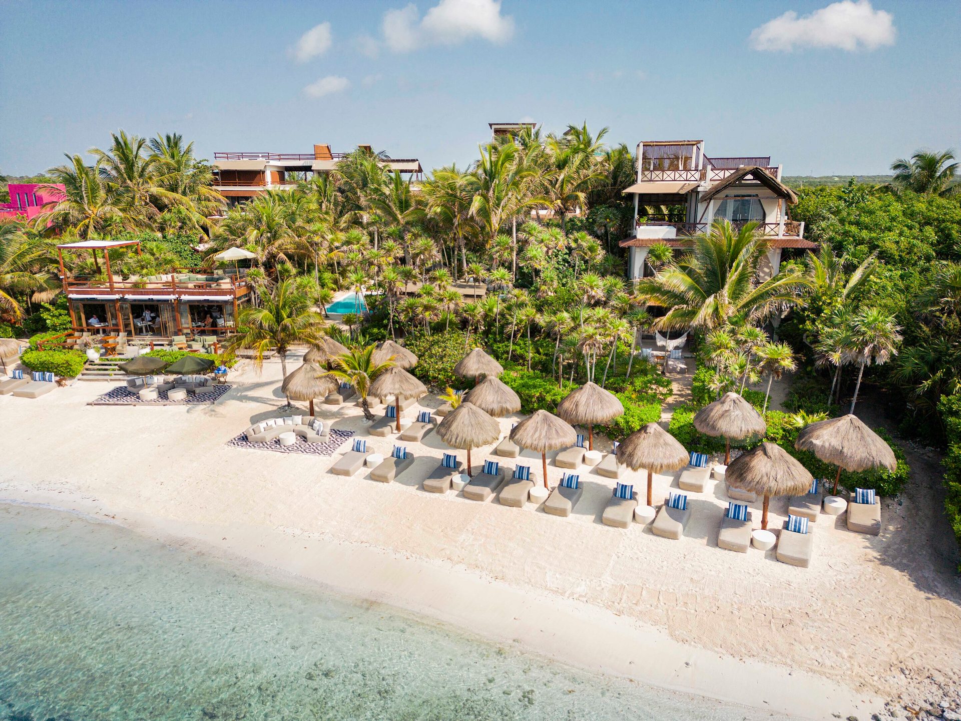 Coastal and oceanic landforms, Seaside resort, Cloud, Sky, Building, Plant, Arecales, Tree, Beach, Travel