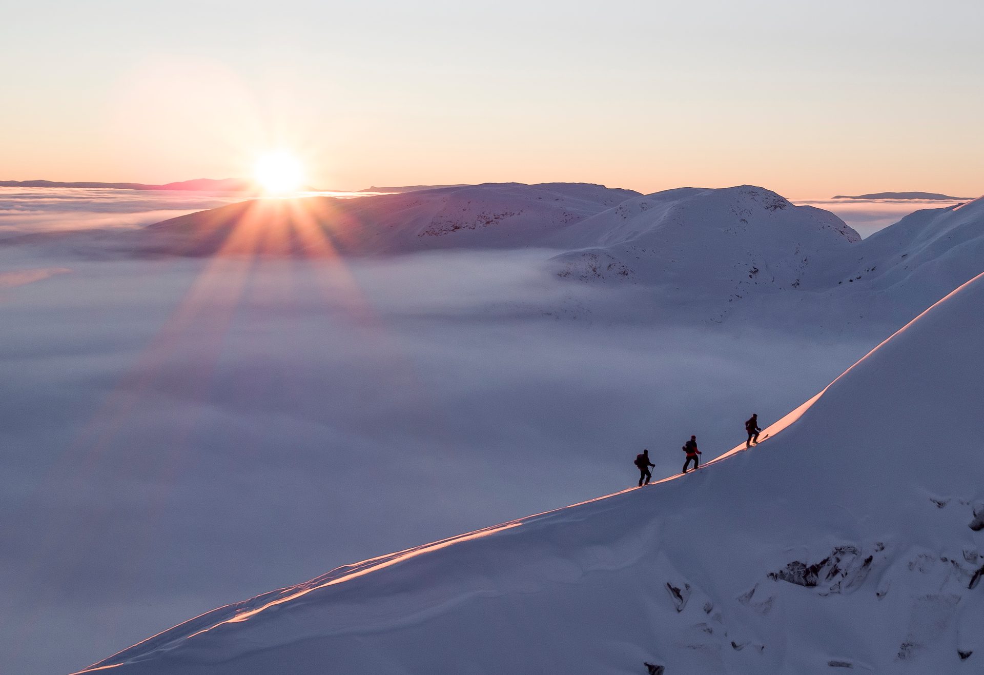Mountainous landforms, Winter sports, Mountain, Sunrise, Snow, Mountaineer, Sun, Recreation, Adventure