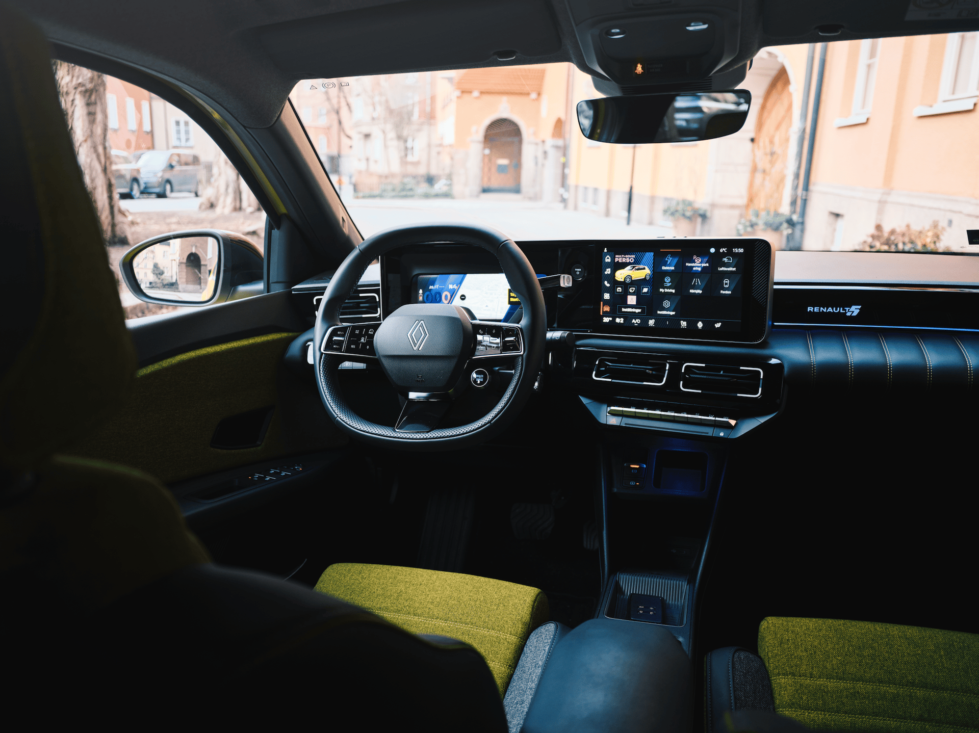 Interior view of a modern car, showcasing the dashboard with digital screens, steering wheel, and green seats.