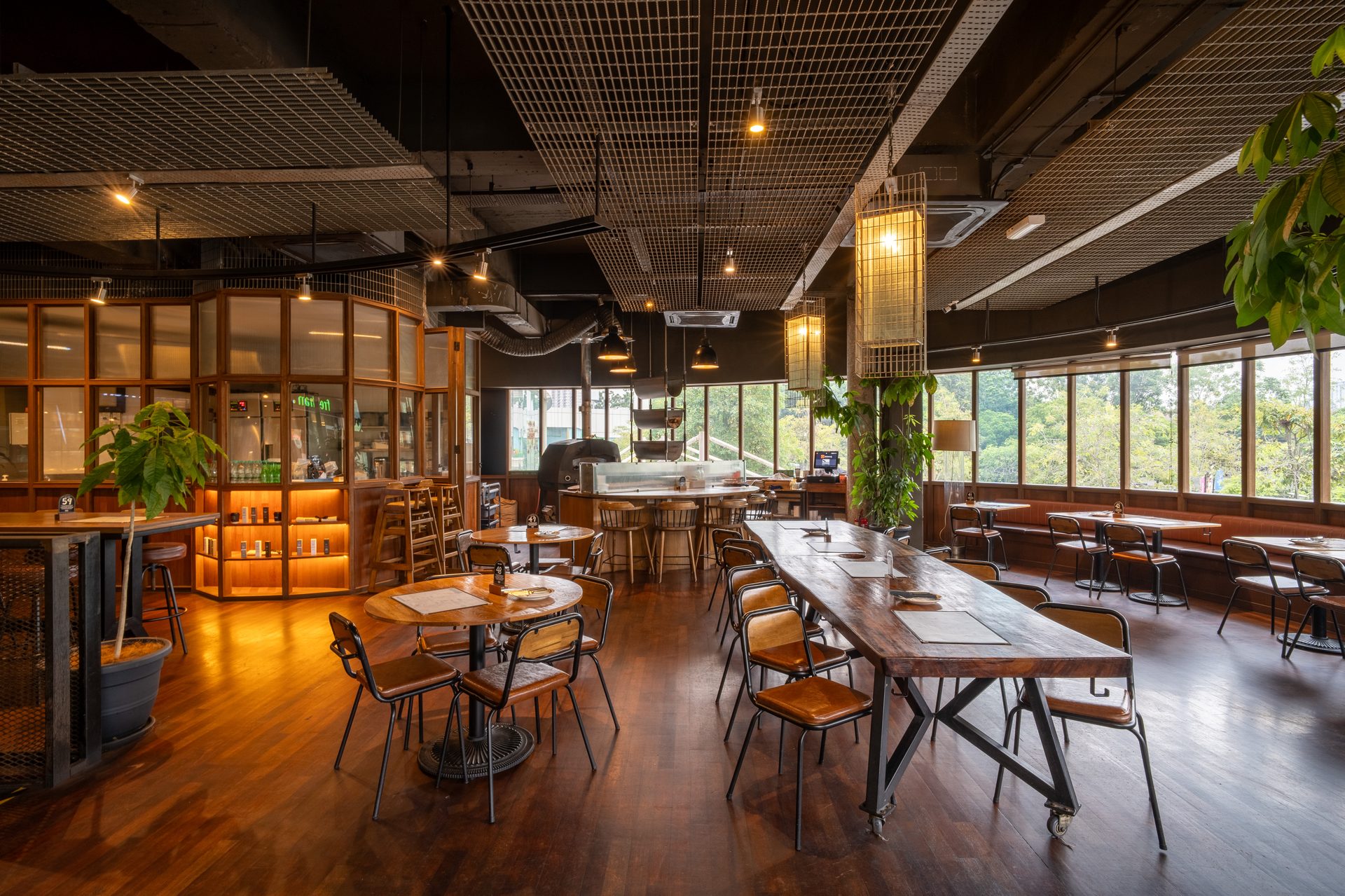 Spacious, modern restaurant with wood, diverse seating, large windows, and industrial ceiling.