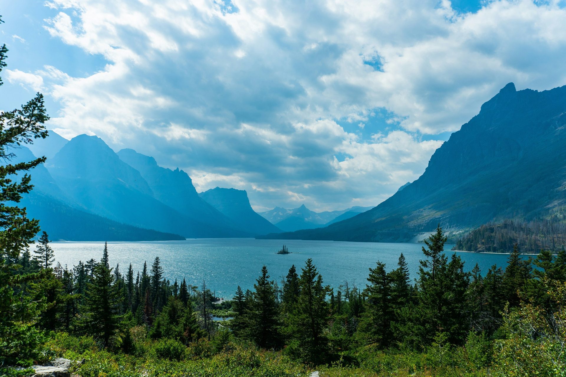 Body of water, Mountainous landforms, Natural landscape, Sky, Mountain, Blue, Cloud, Nature, Green