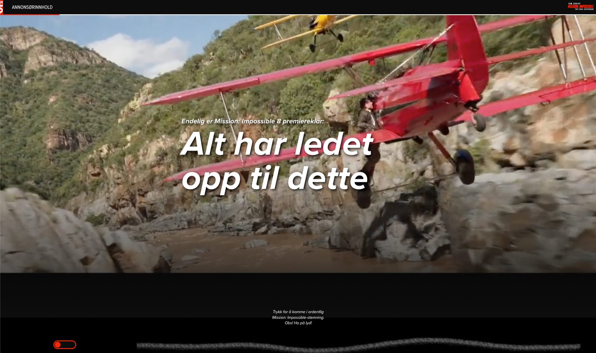 Red biplane flying through a rocky canyon, promoting Mission: Impossible 8.