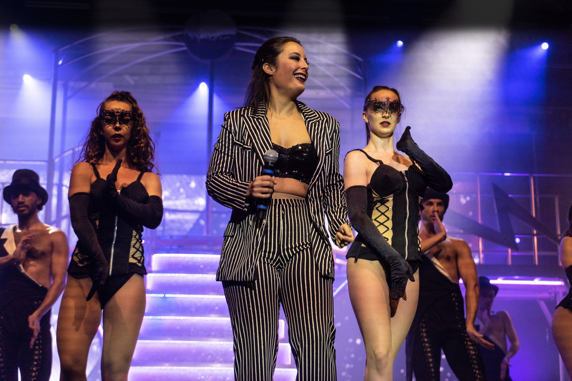 Music artist, Performing arts, Microphone, Musician, Purple, Concert, Entertainment, Dress, Thigh